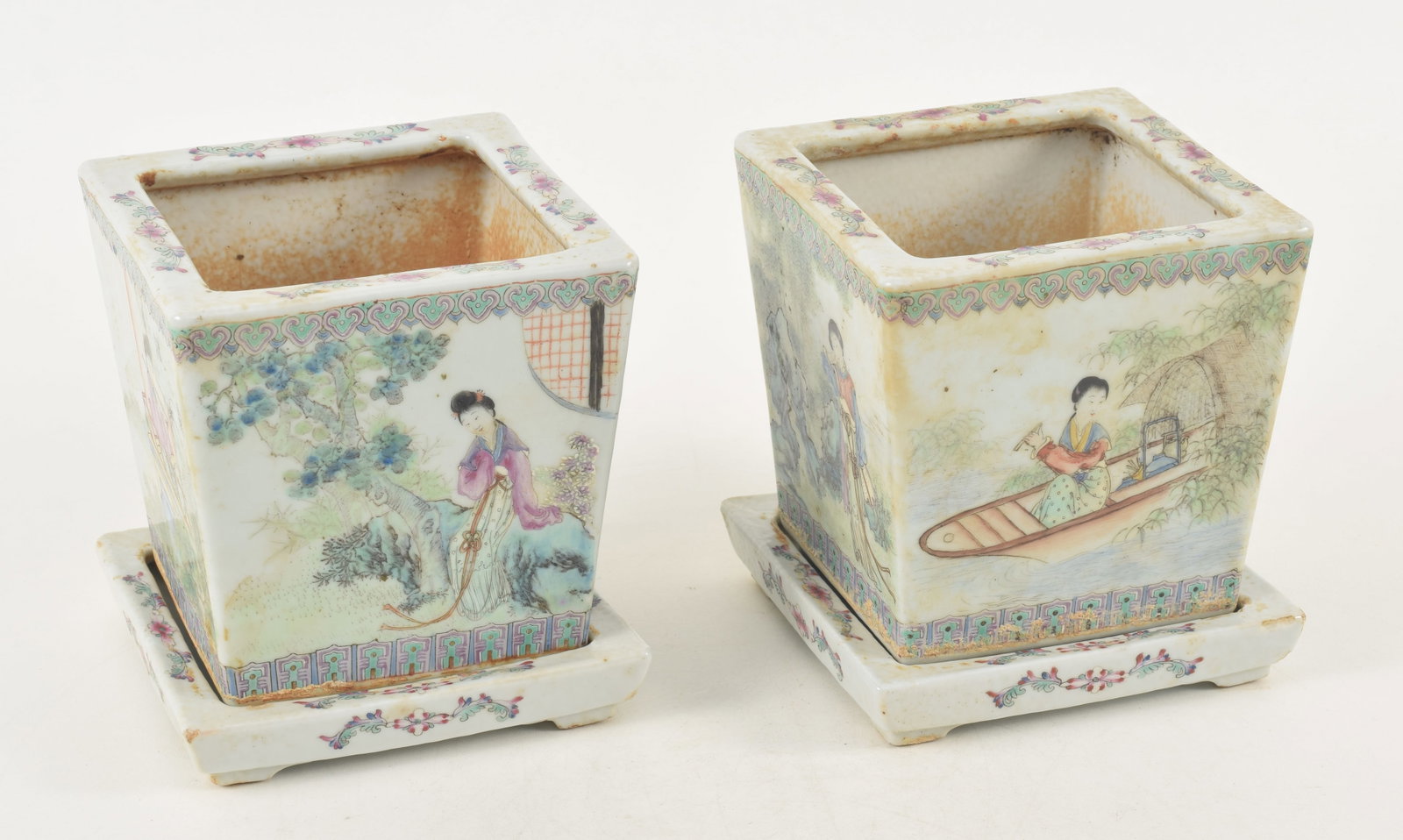 Pair of Chinese Republic Period porcelain planters on stands. Famille rose decoration of women in: Pair of Chinese Republic Period porcelain planters on stands. Famille rose decoration of women in landscape scenes. Square bases with floral decoration. Calcification from water. Glaze loss. Red seals