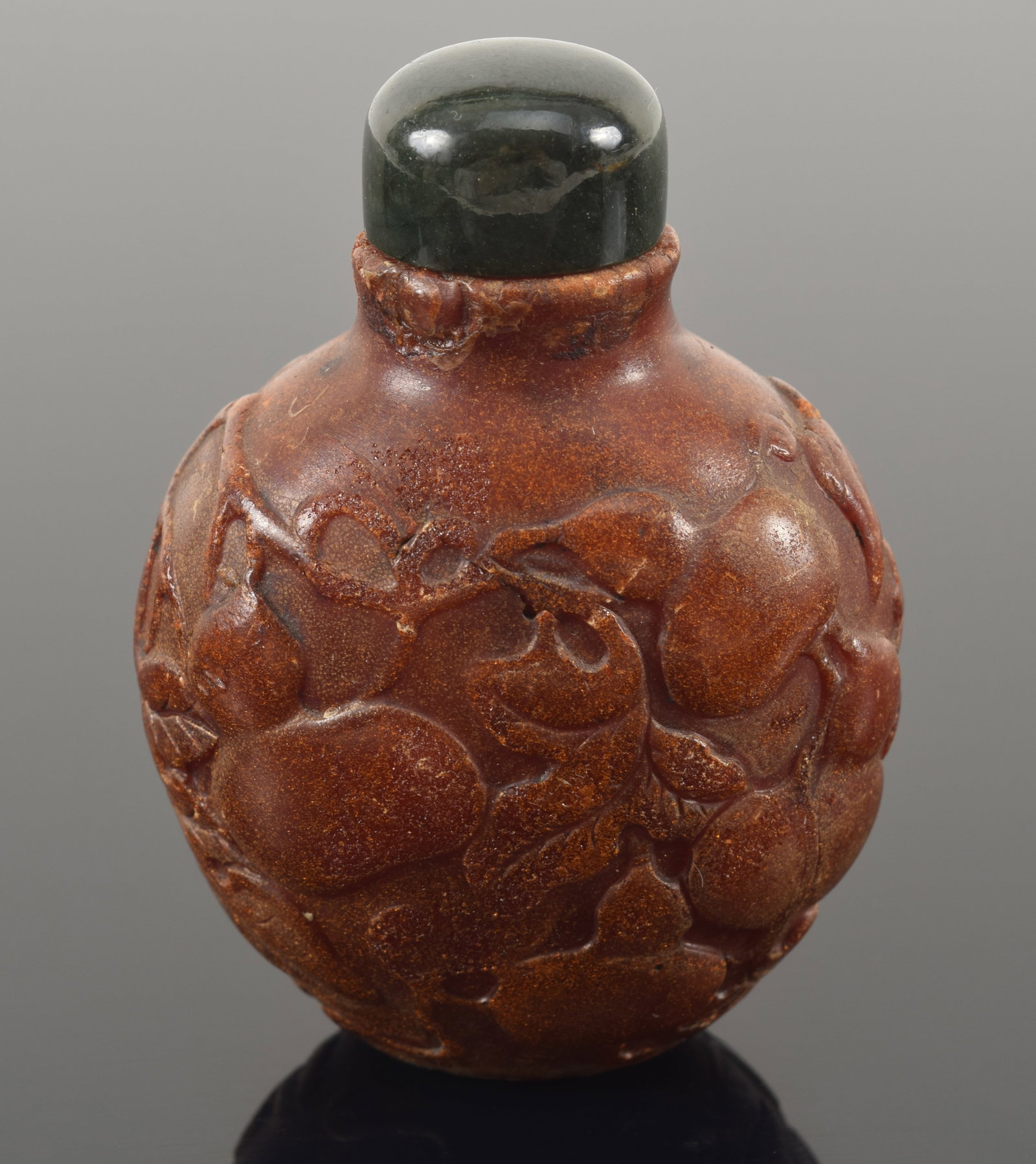 19th century Chinese carved amber snuff bottle. Allover fruit decoration. Chips around top rim. (1 of 7)