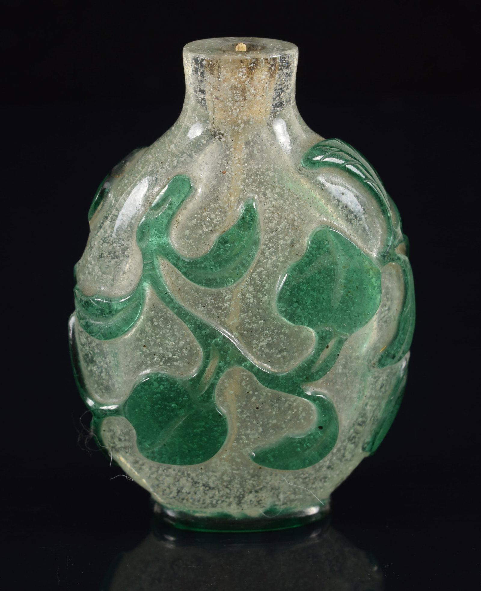 19th century Chinese Peking glass snuff bottle. Green over clear snowflake. Branch and bat: 19th century Chinese Peking glass snuff bottle. Green over clear snowflake. Branch and bat decoration. No stopper. 2 1/8in high.