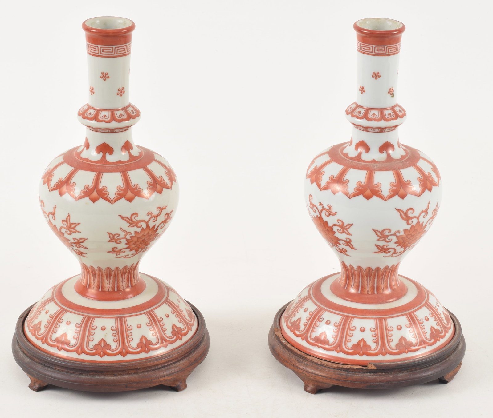 Pair of Chinese porcelain candlesticks. Late 19th century. Iron red decoration of lotus blossoms and (1 of 8)