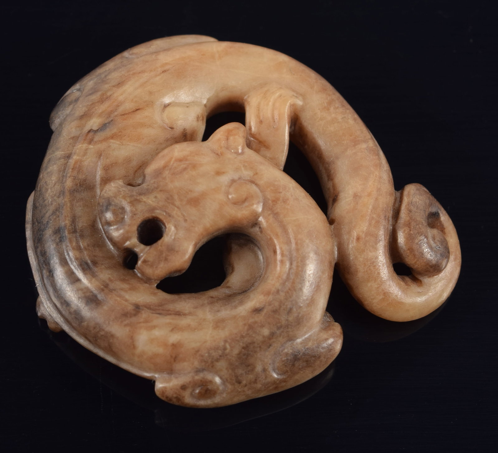 Jade pendant. China. Liao period. Brownish colored jade carved in a roundel as a dragon. 1.5in. (1 of 4)