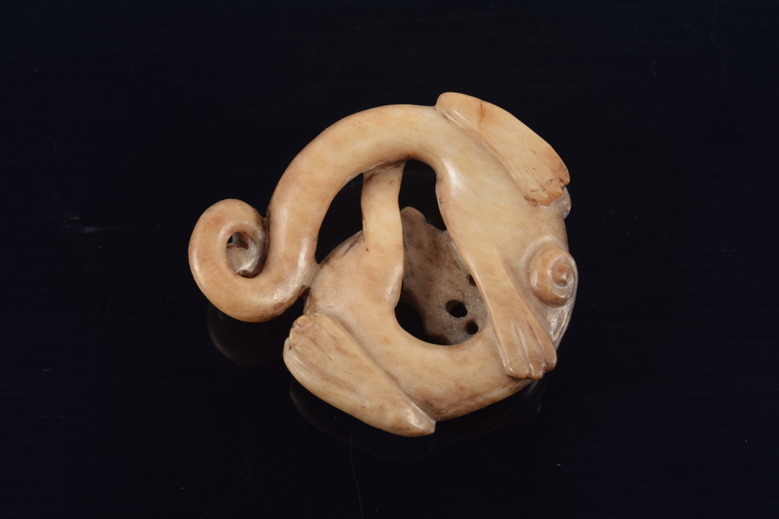 Jade pendant. China. Liao period. Brownish colored jade carved in a roundel as a dragon. 1.5in. - 3