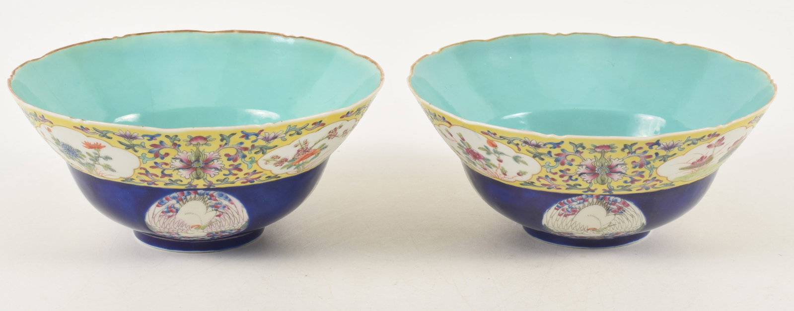 Pair of porcelain bowls. China. Late 19th century. Upper register of floral motifs on a floral: Pair of porcelain bowls. China. Late 19th century. Upper register of floral motifs on a floral ground. Lower register with crane roundels and a deep cobalt ground. Chia Ching marks. Old hairline on ri