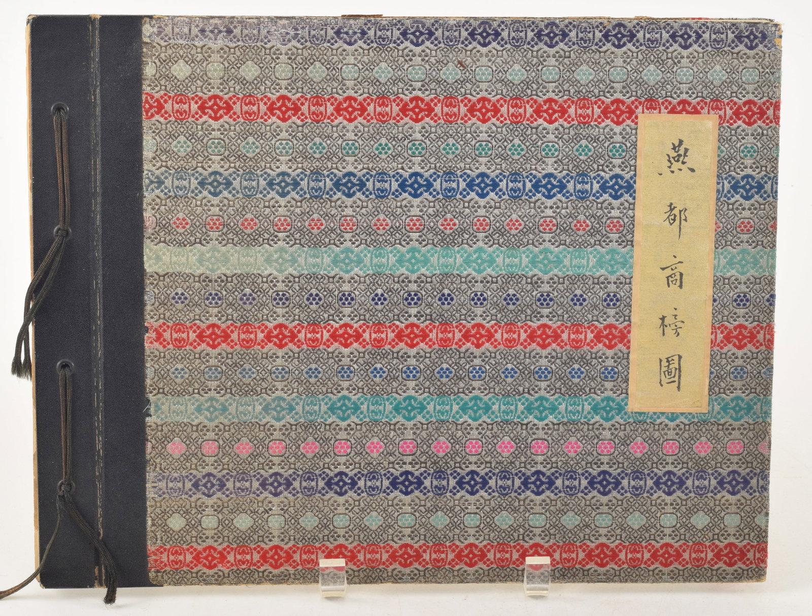 The Shop Signs of Peking. Chinese Painting Association of Peking: Peking, 1931. Over 100 hand: The Shop Signs of Peking. Chinese Painting Association of Peking: Peking, 1931. Over 100 hand painted illustrations of various Chinese shop signs, all identified. Silk brocade binding. 10.25 x 13.5in.