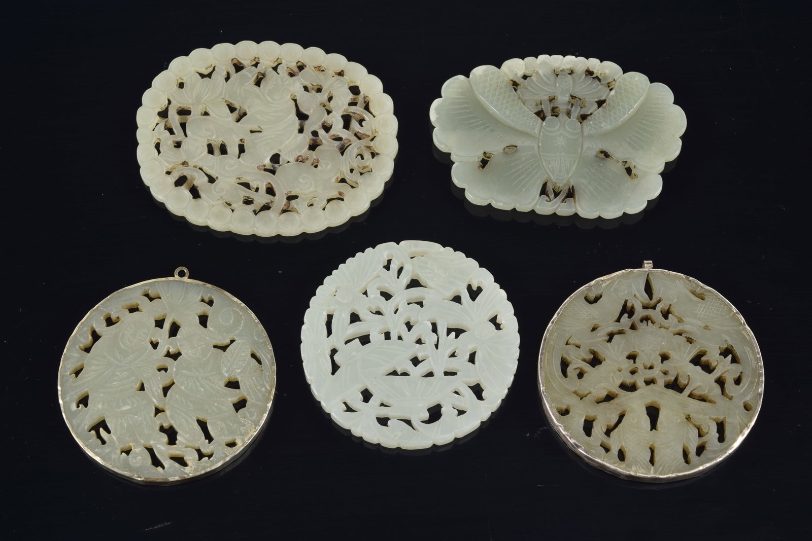4 jade pendants. China. 19th to early 20th century. One silver mounted. 3in. (1 of 7)