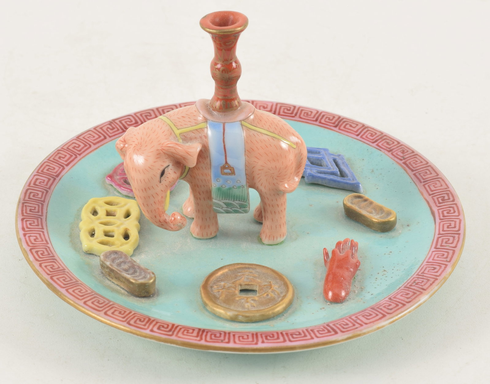 Porcelain incense stick holder. China. Chia Ching mark and possibly of the period. Decoration of: Porcelain incense stick holder. China. Chia Ching mark and possibly of the period. Decoration of various molded objects, an elephant, coins and other objects. 5.25 x 3.25in.