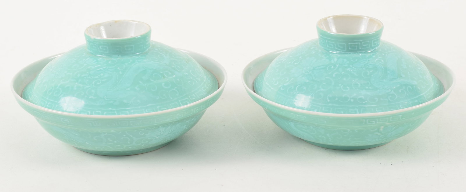 19th/20th century Chinese turquoise ground covered porcelain bowls. Dragon and white floral: 19th/20th century Chinese turquoise ground covered porcelain bowls. Dragon and white floral scrolling underglaze decoration. Chien Lung seal marks. 6in diameter. 3.25in high.