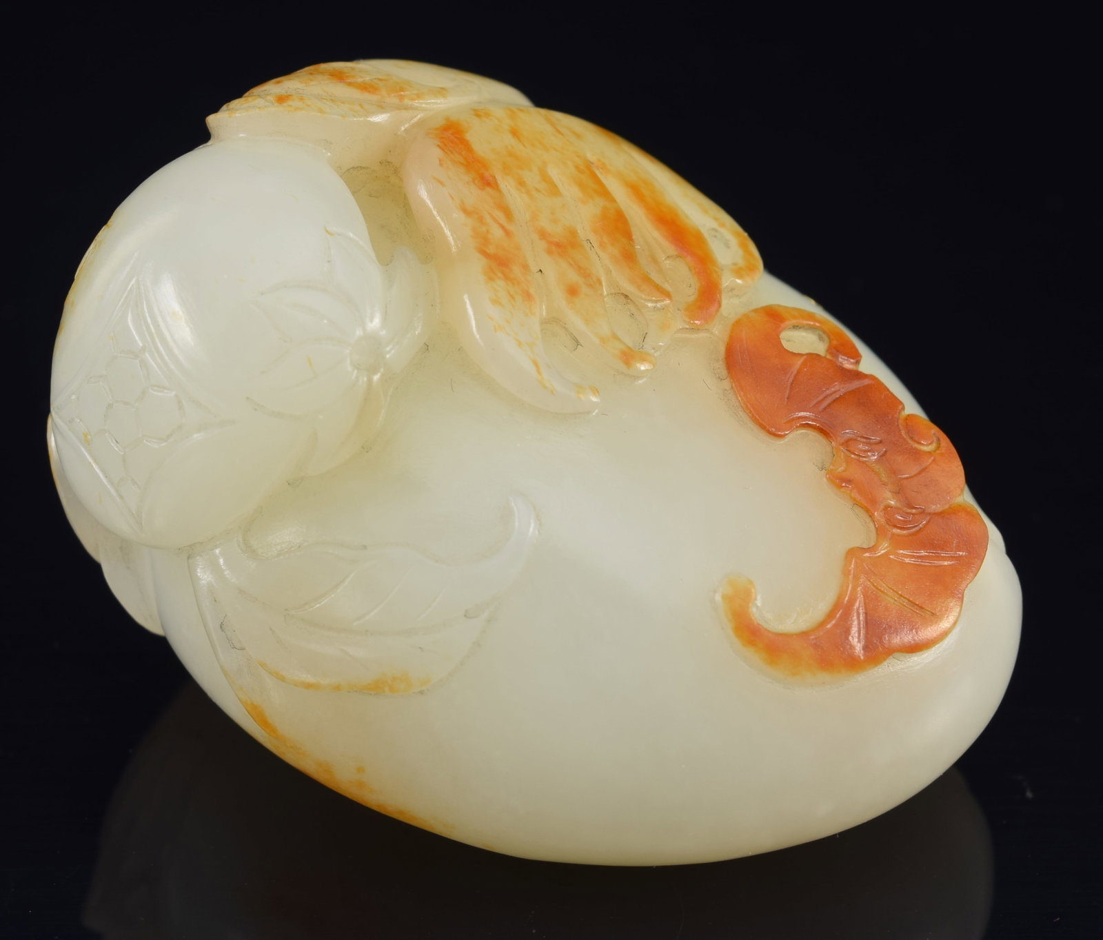 Jade pendant. China. 18th century. Carving of peaches and bats. Stone of a pure white color with: Jade pendant. China. 18th century. Carving of peaches and bats. Stone of a pure white color with russet areas. 2in.