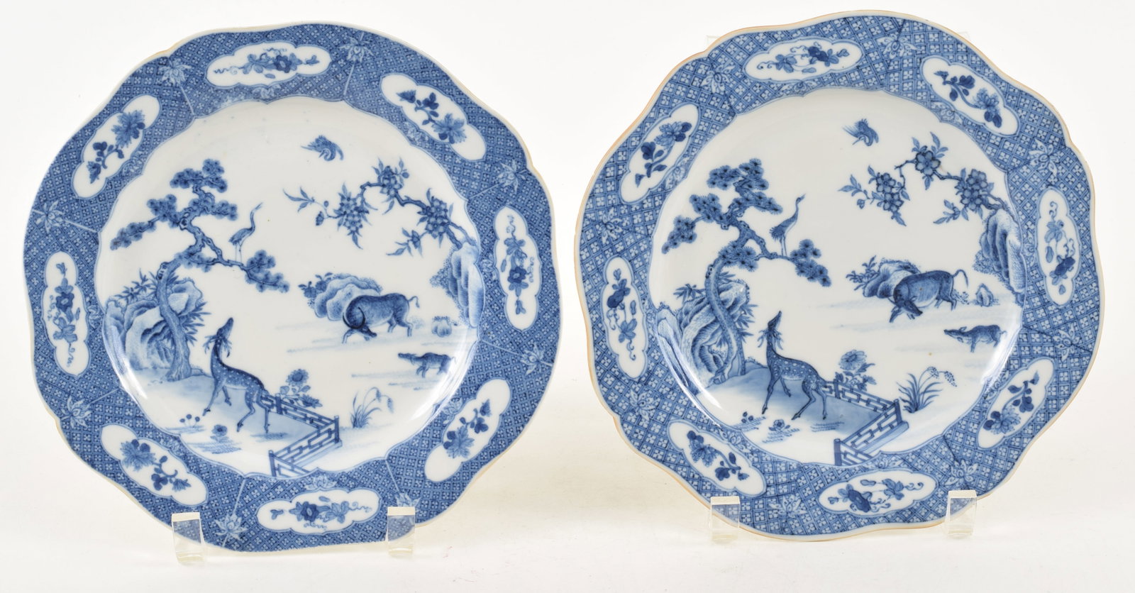 Pair of 18th century Chinese blue and white porcelain shaped edge plates. Deer, water buffalo, and: Pair of 18th century Chinese blue and white porcelain shaped edge plates. Deer, water buffalo, and cranes in a landscape. Floral borders. 8.75in diameter.