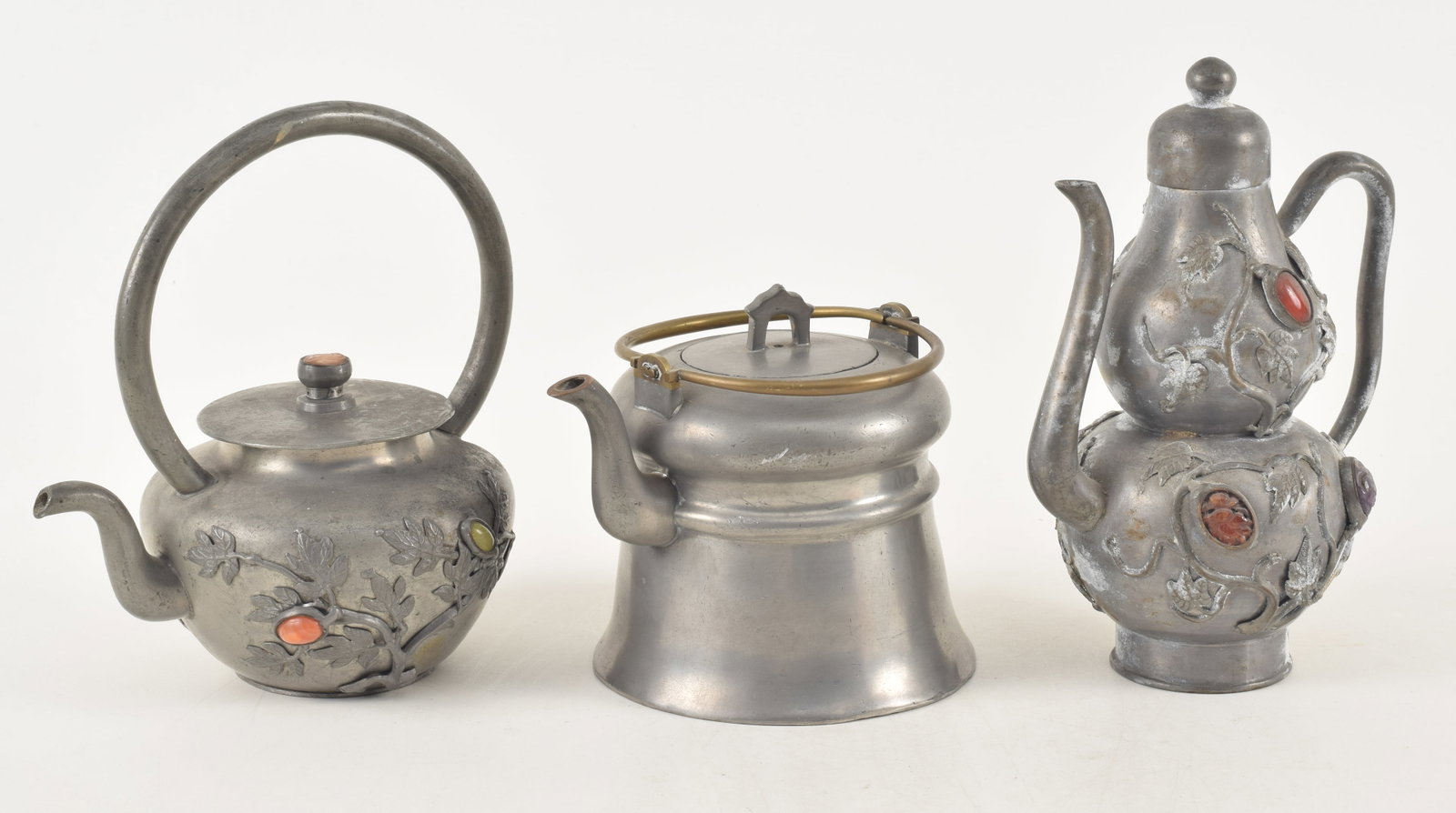 Lot of 3 antique Chinese pewter teapots. 1) Wide brass handled teapot. 2) Stone mounted relief: Lot of 3 antique Chinese pewter teapots. 1) Wide brass handled teapot. 2) Stone mounted relief decorated teapot. 3) Tall stone mounted double gourd wine ewer. 8in high.