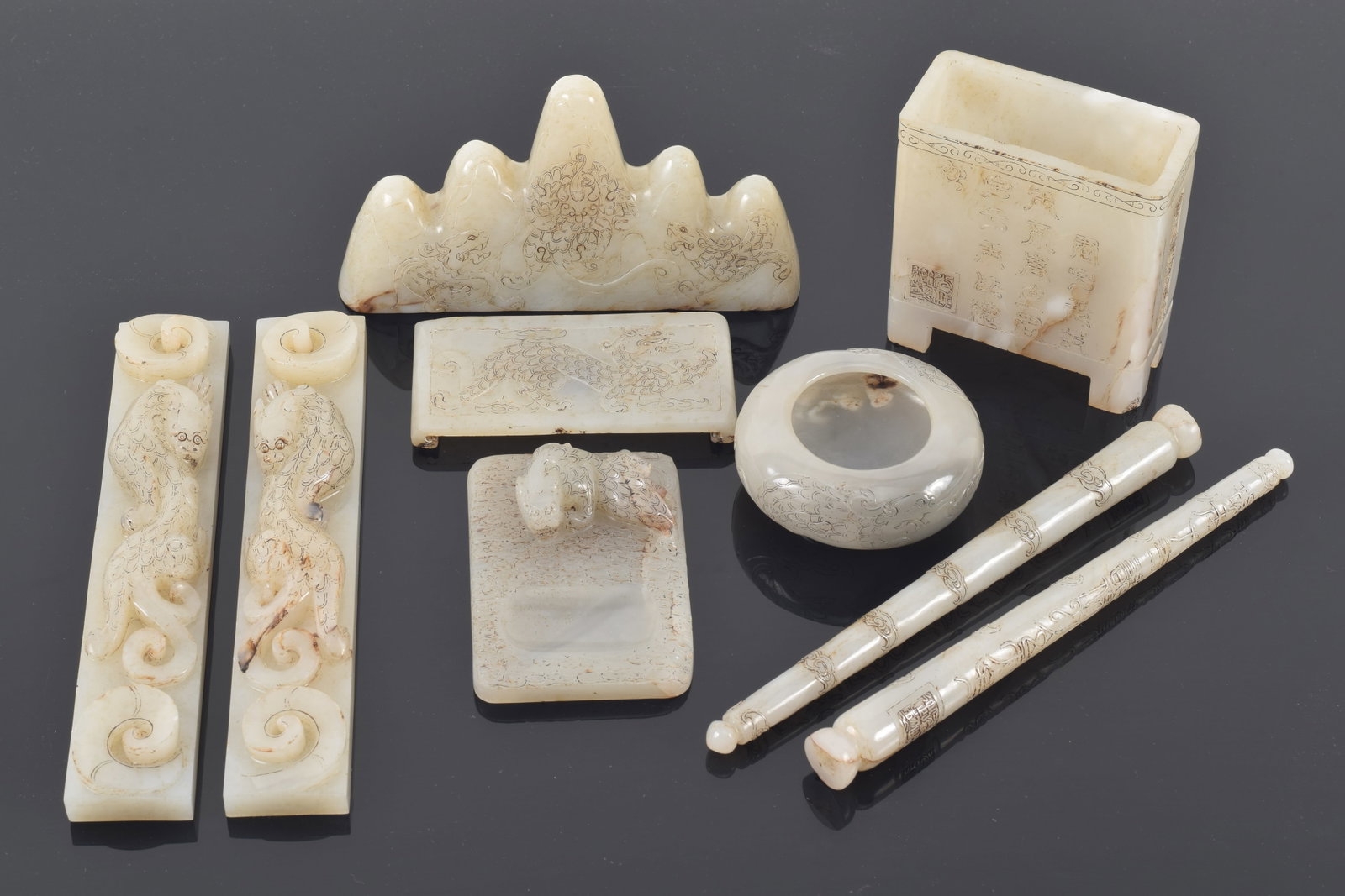 Desk set. China. Late 19th/early 20th century. Grey-white jade. Set of 9 pieces: brush holder,: Desk set. China. Late 19th/early 20th century. Grey-white jade. Set of 9 pieces: brush holder, paperweight (2), brushes (2), pen rest, ink stand, water coupe, and inkstone. Largest 8in.