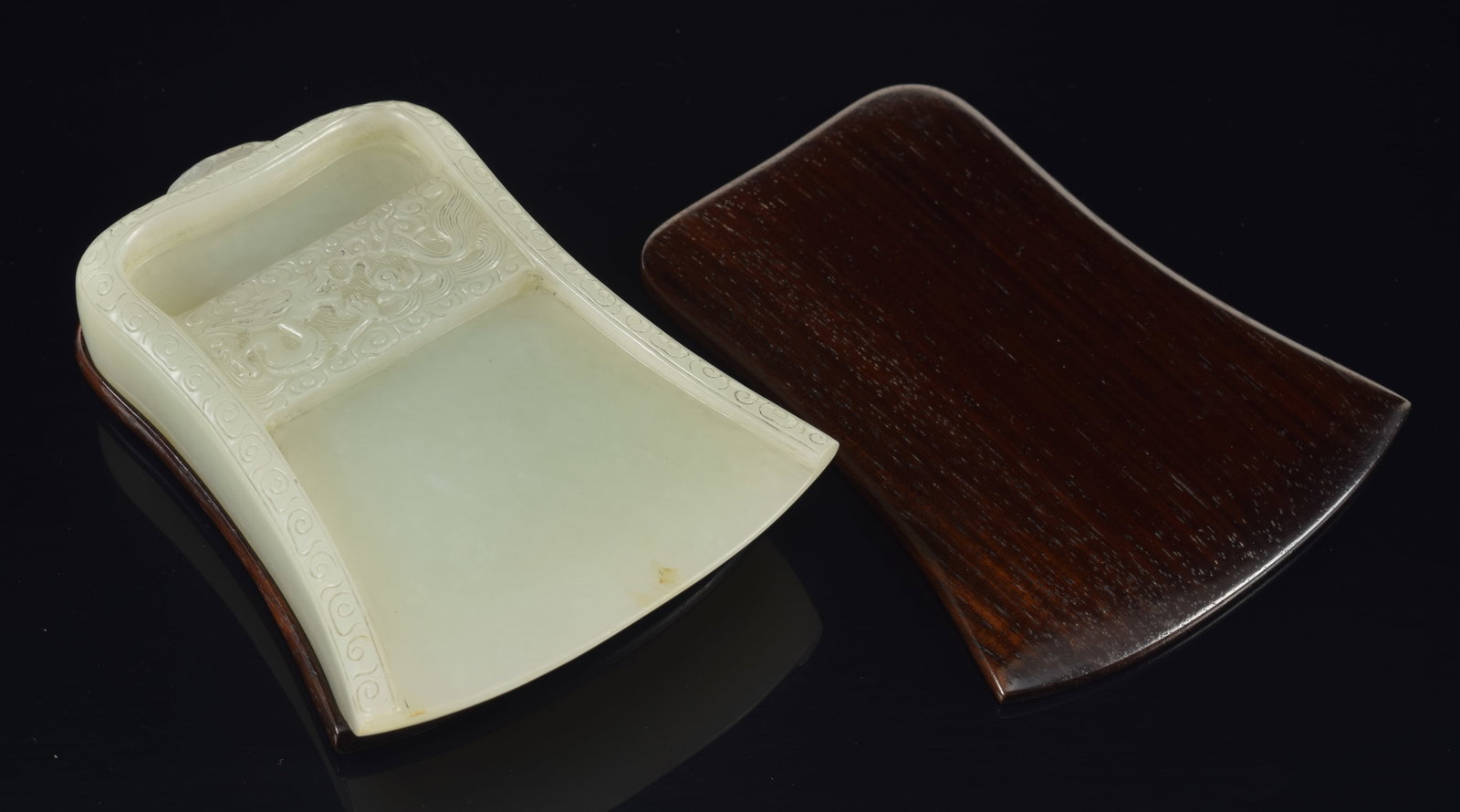 Jade inkstone. China. 18th century. Axe shaped. Decoration in relief of dragons and clouds. Pale (1 of 6)