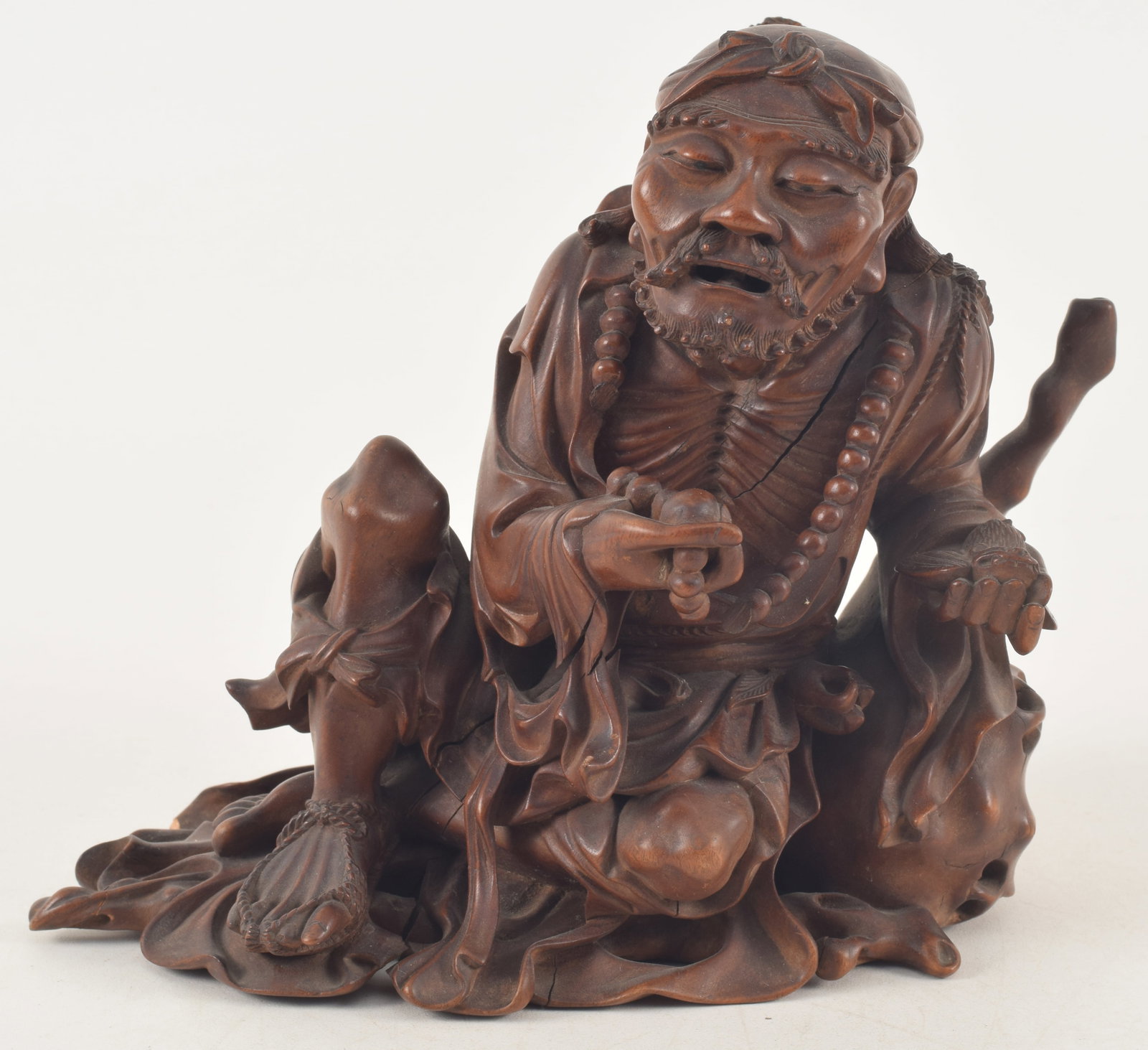 Rosewood carving. China. 19th century. Seated figure of the immortal Li Tieh Kuai. 7.5 x 6.5in.: Rosewood carving. China. 19th century. Seated figure of the immortal Li Tieh Kuai. 7.5 x 6.5in. Cracks.