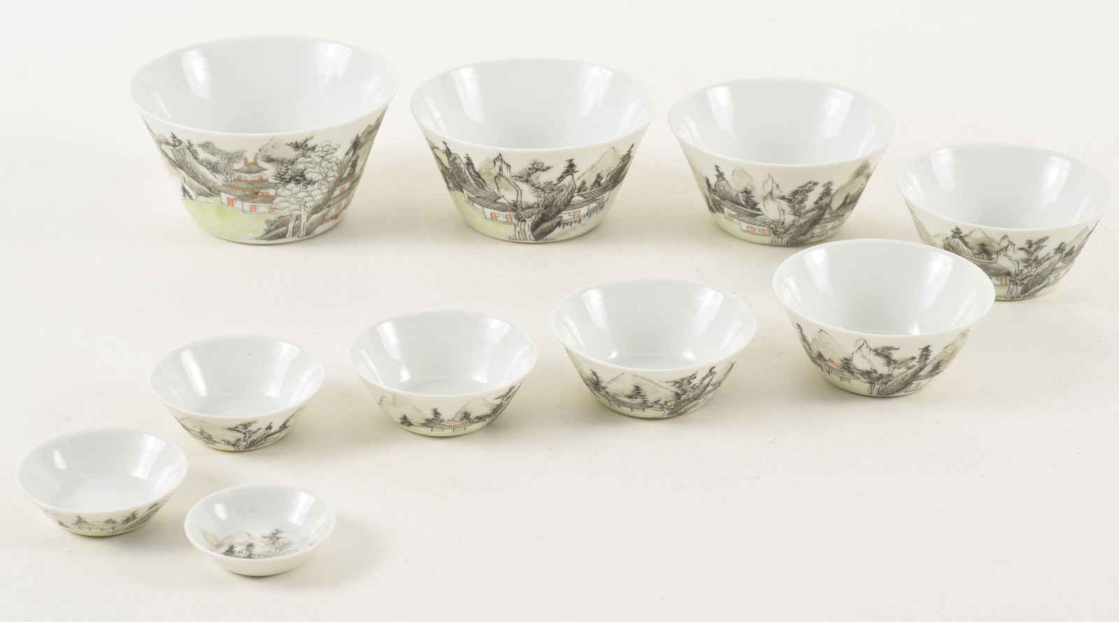 Nest of 10 Chinese porcelain graduated stacking cups, early 20th century. Landscape decoration.: Nest of 10 Chinese porcelain graduated stacking cups, early 20th century. Landscape decoration. Largest: 4.25in diameter, 2.875in high.