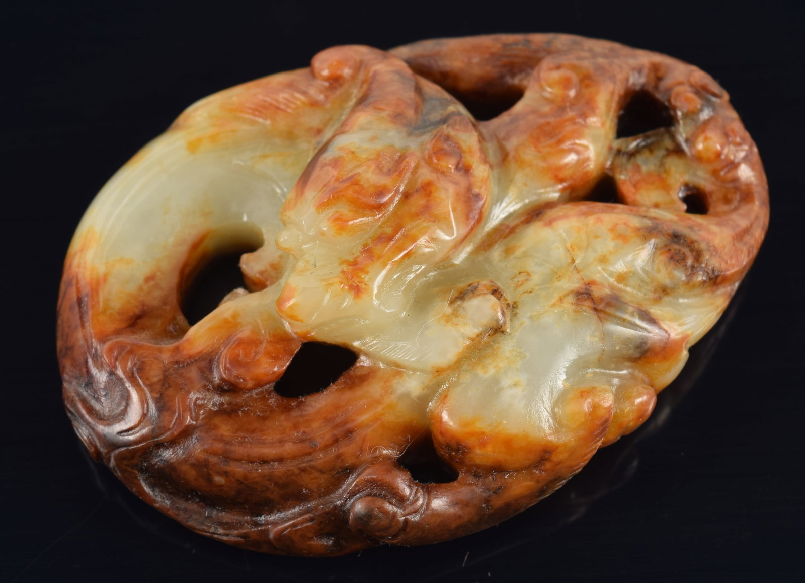 Jade carving of a dragon. China. 19th/20th century. Dark russet stone with celadon colored band. (1 of 3)