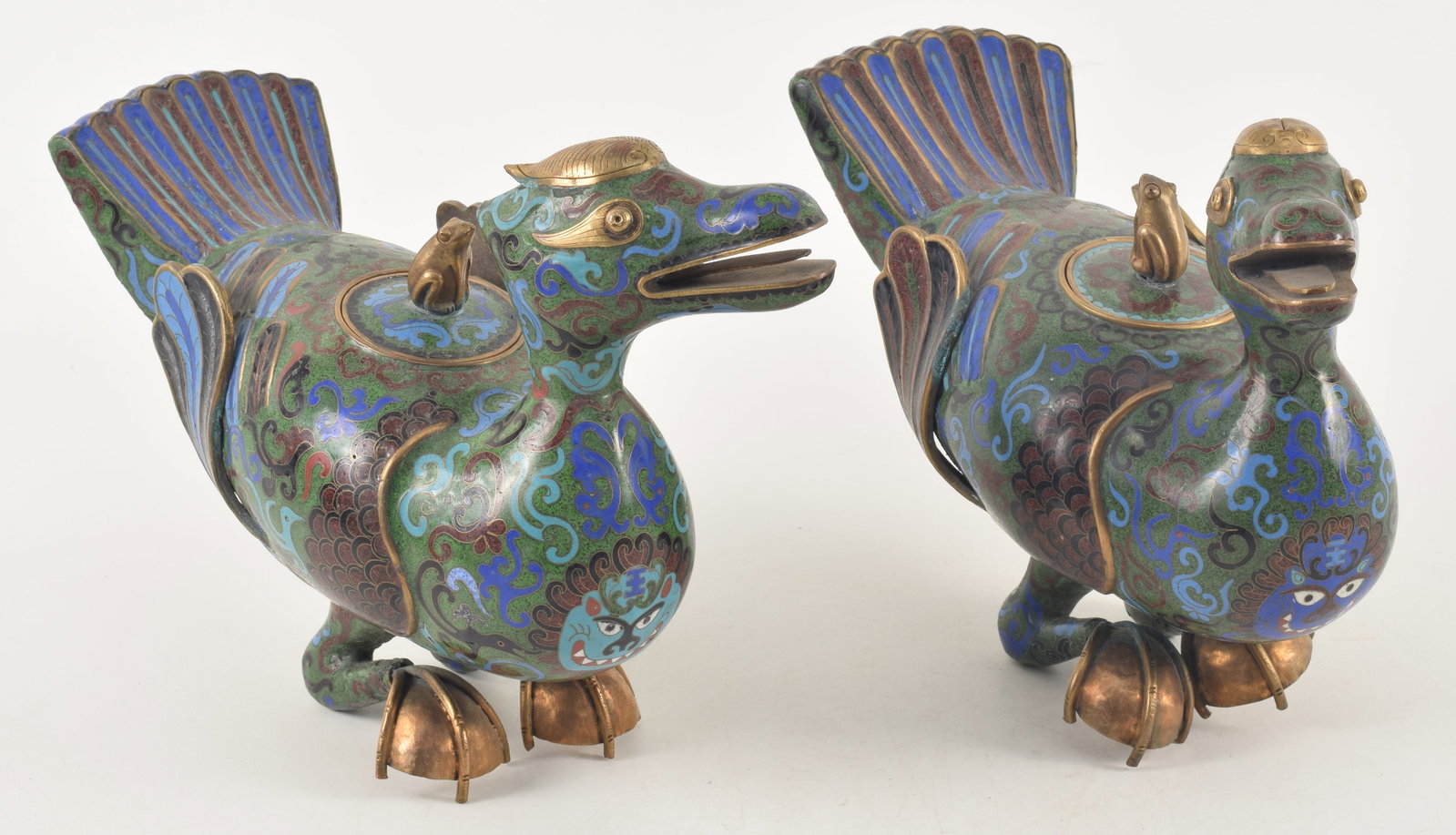 Pair of Chinese cloisonne phoenixes, early 20th century. Frog finials on lids. Foot of one bent.: Pair of Chinese cloisonne phoenixes, early 20th century. Frog finials on lids. Foot of one bent. 12in length.