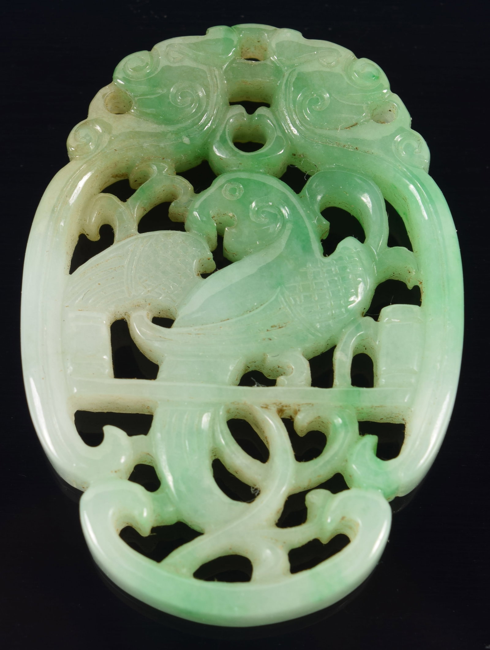 Carved and pierced jadeite pendant. China. 19th century. Carved with a parrot. 1.75in. (1 of 4)