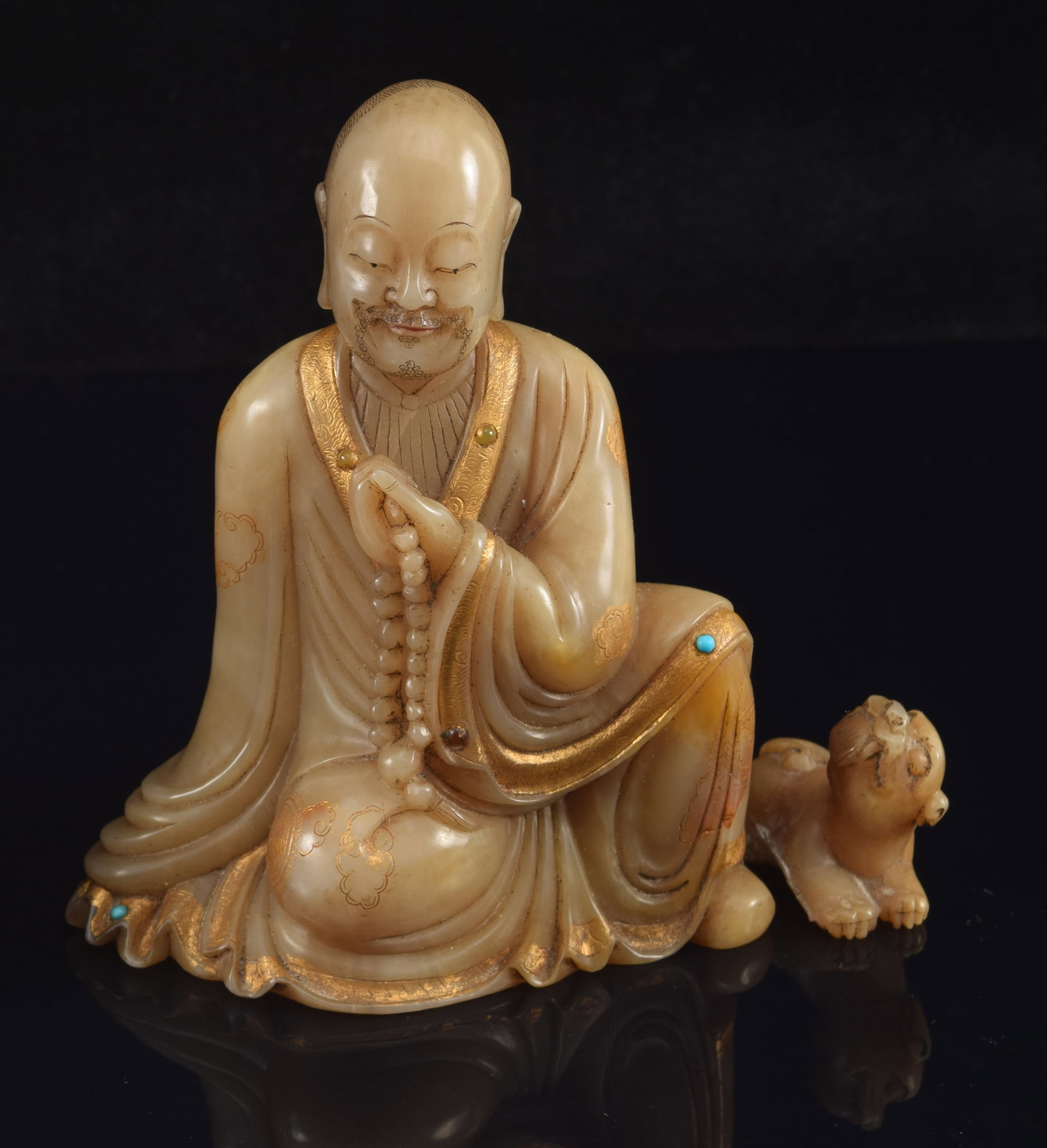 Soapstone Luohan. China. 19th century. Seated figure with a foo dog. (Broken off and detached). (1 of 7)