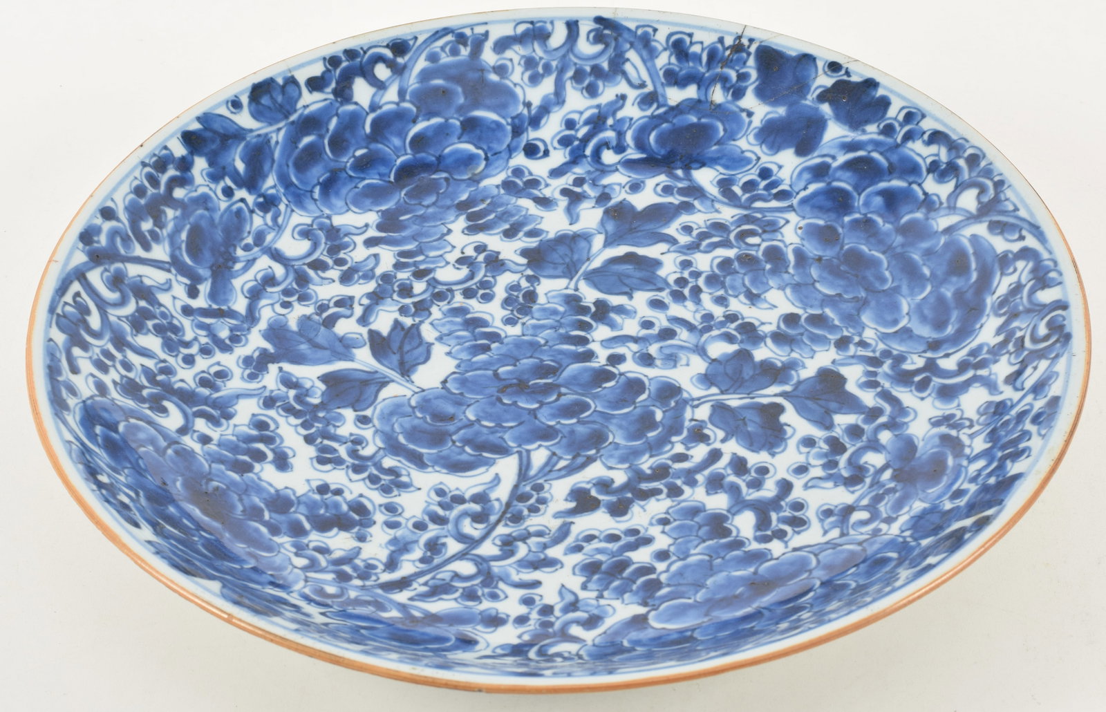 19th century Chinese porcelain charger. Blue and white floral decoration. Repaired breaks on side of (1 of 7)