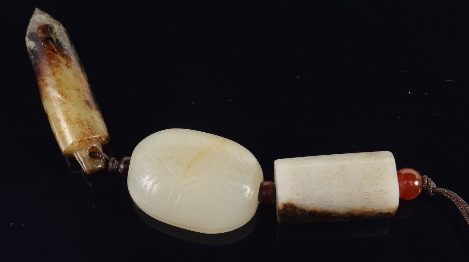 Jade hanging pendant. China. 18th/19th century. Composed of 3 elements. Archaic style jade. Each (1 of 11)