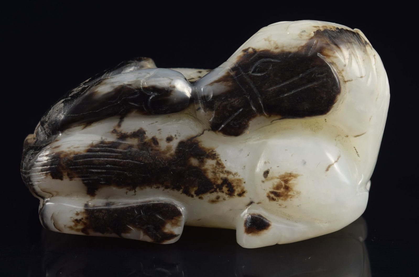 Jade carving. China. 18th century. Pure white with black markings. Decoration of a pi and horse.: Jade carving. China. 18th century. Pure white with black markings. Decoration of a pi and horse. 2.25in.