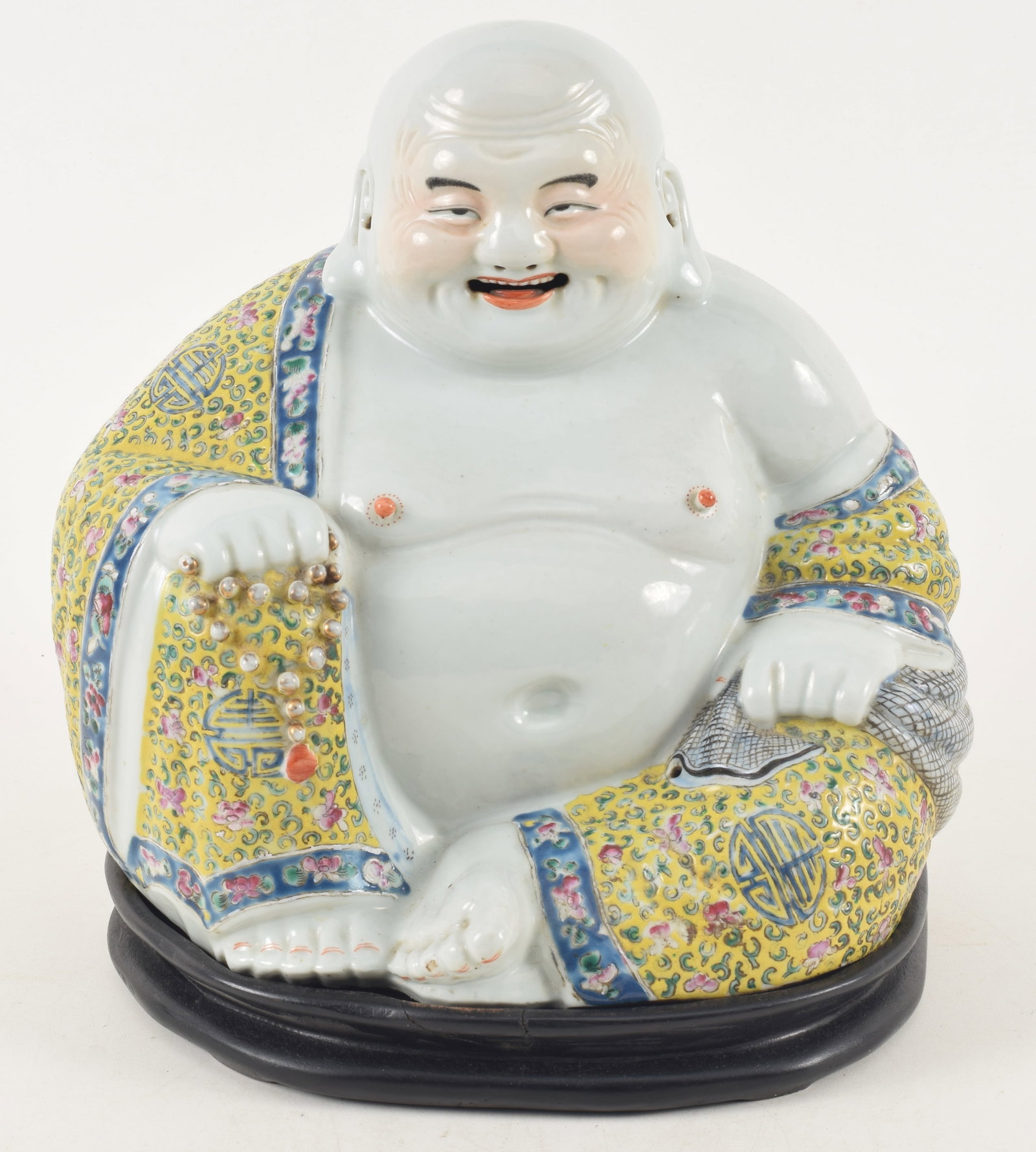 Chinese porcelain seated buddha, early 20th century. Partial hallmark on base. Fitted wood stand.: Chinese porcelain seated buddha, early 20th century. Partial hallmark on base. Fitted wood stand. 11.5in high, 10.5in wide.