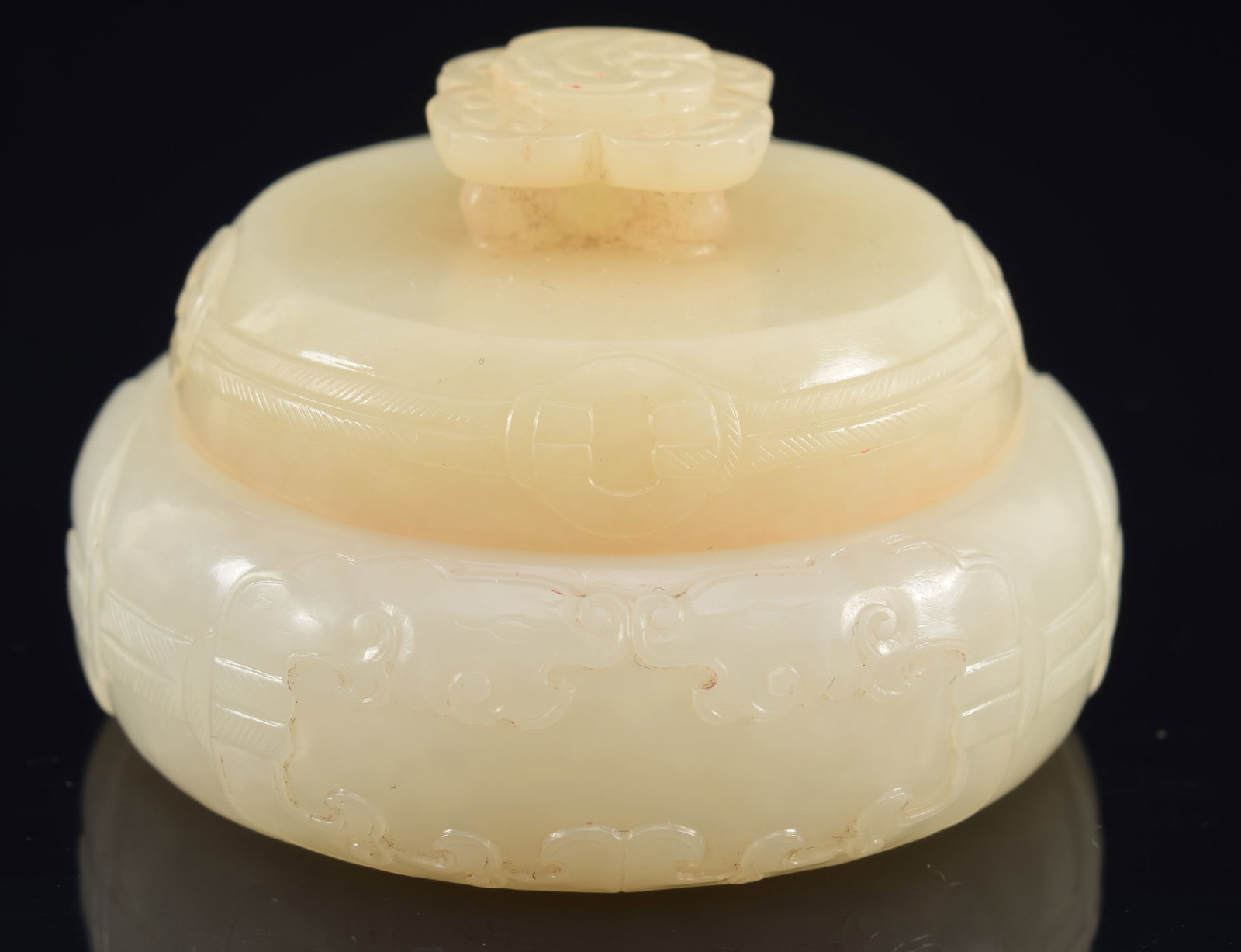 Jade covered box. China. Chien Lung period (1735-1796). Rui shaped handle. Surface carved with (1 of 8)