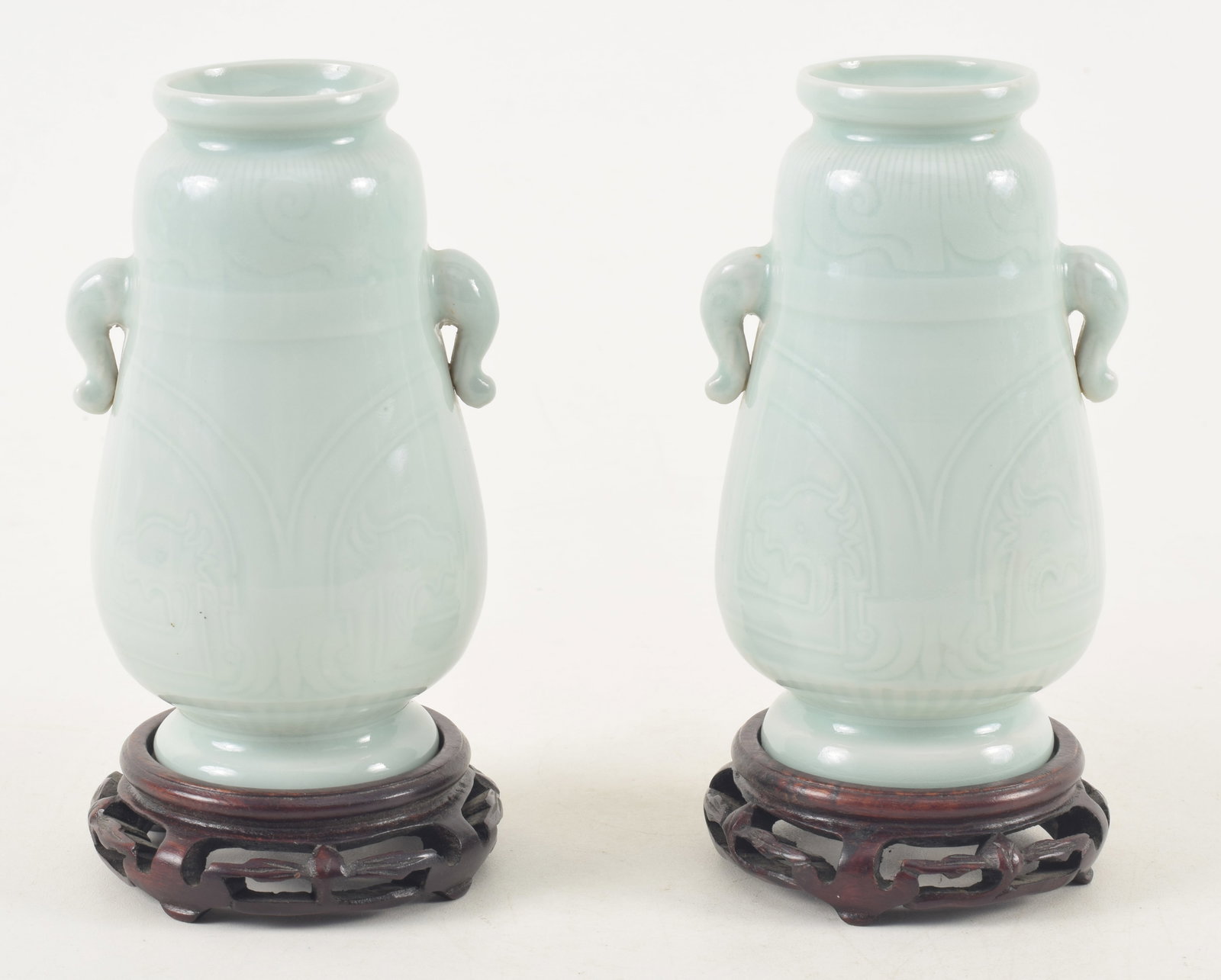 Pair of porcelain vases. China. Early 20th century. Archaic style carving with a pale celadon glaze. (1 of 15)