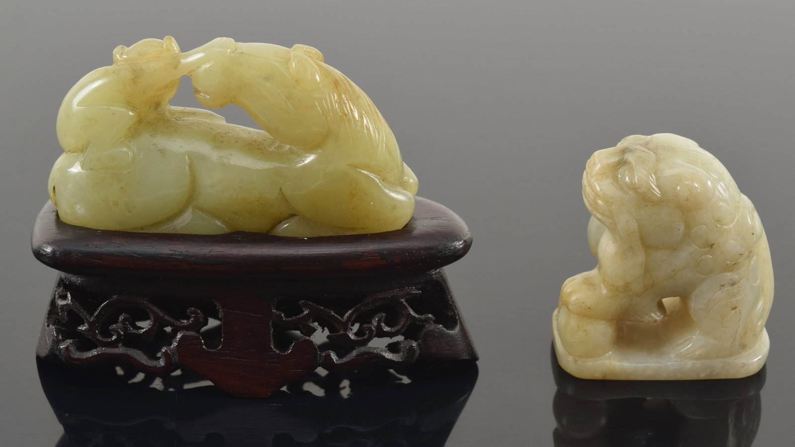 2 jade carvings. China. 19th/20th century. 1) Green jade horse and monkey. 2) Pale celadon buddhist (1 of 4)