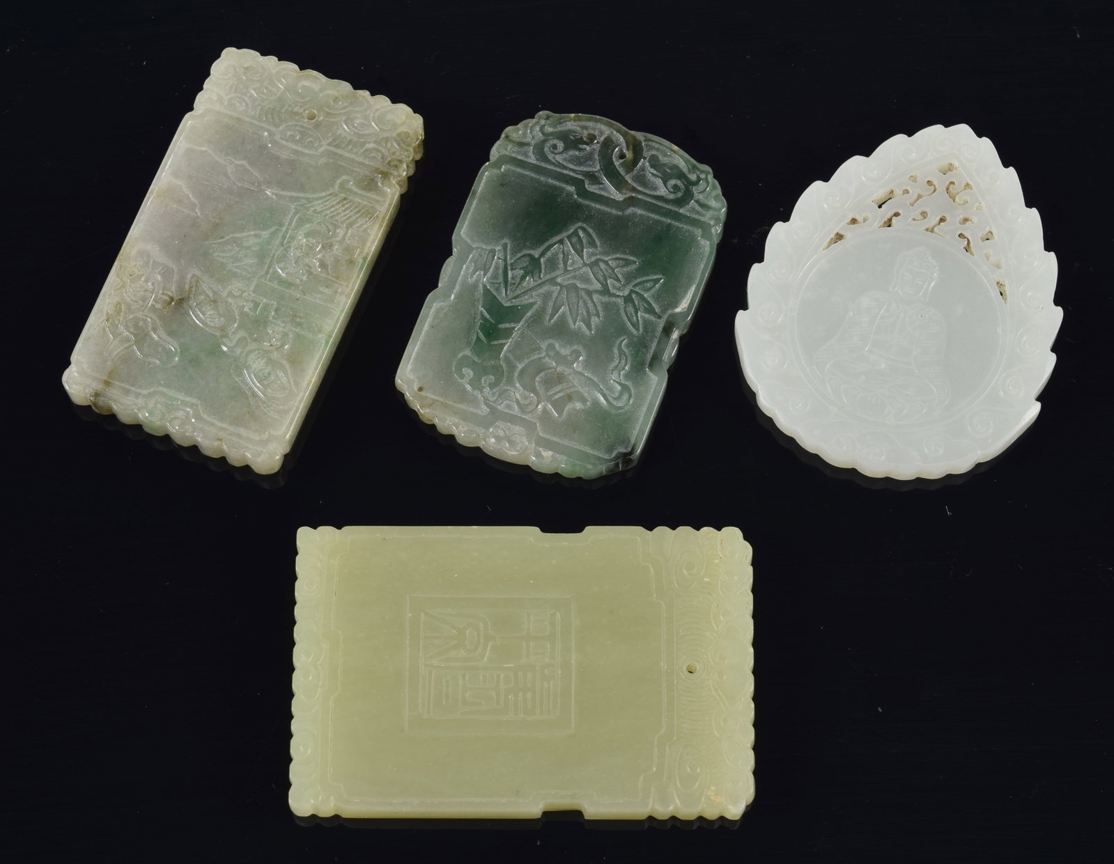 4 jade pendants. China. 19th century. To include: a yellow rectangular pendant, 2 grey pendants, and (1 of 6)
