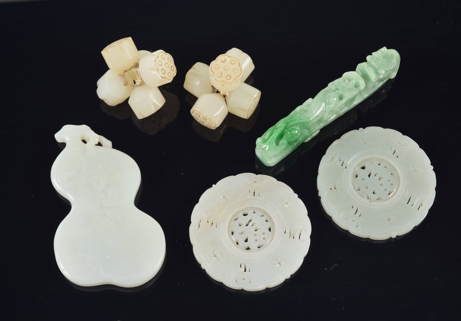 4 jade pendants. China. 19th century. Together with a group of jade lotus beads. Largest 3in. (1 of 6)