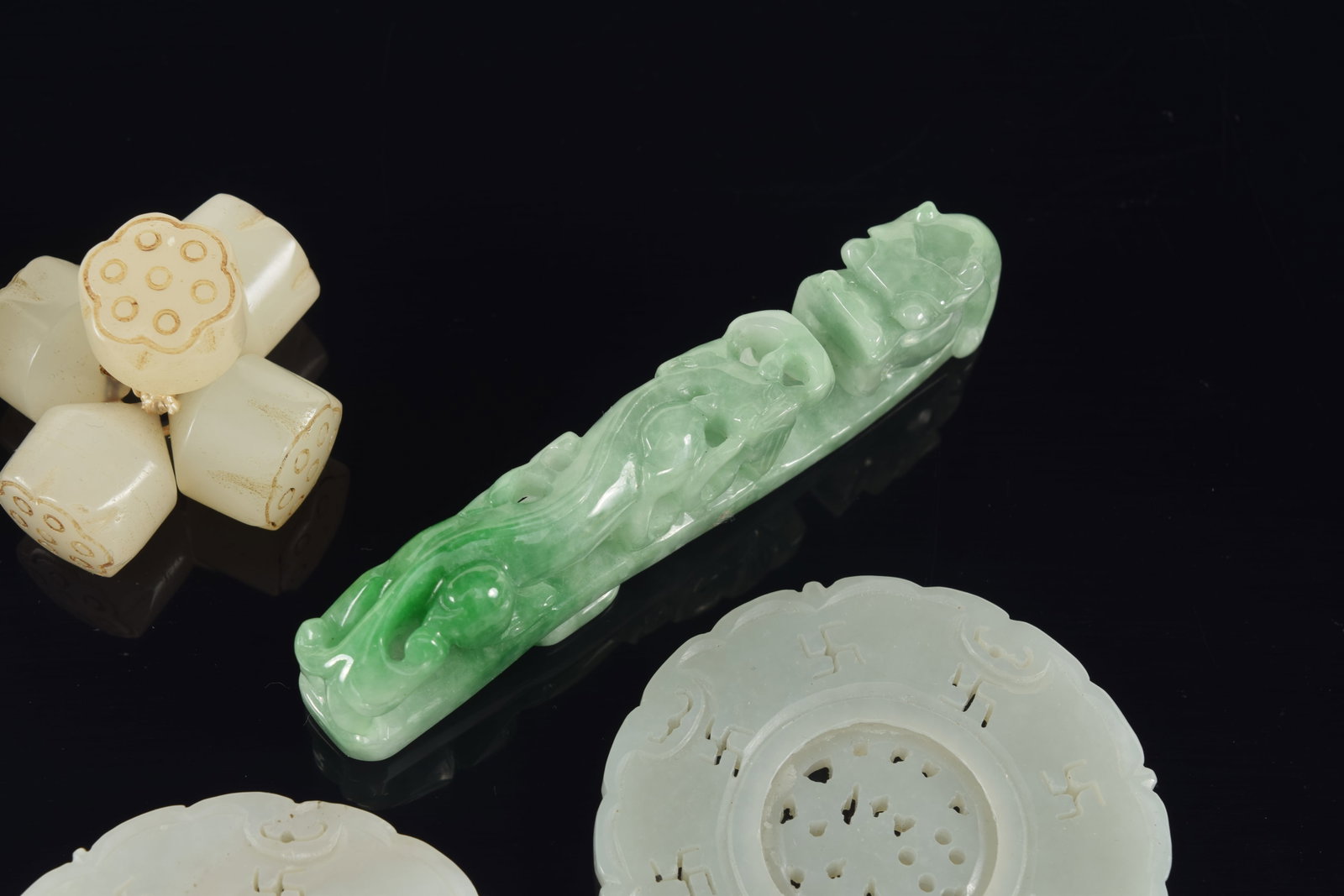 4 jade pendants. China. 19th century. Together with a group of jade lotus beads. Largest 3in. - 3