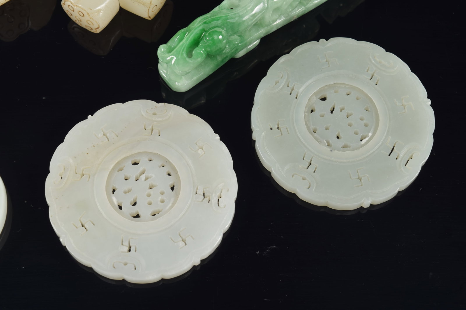 4 jade pendants. China. 19th century. Together with a group of jade lotus beads. Largest 3in. - 4