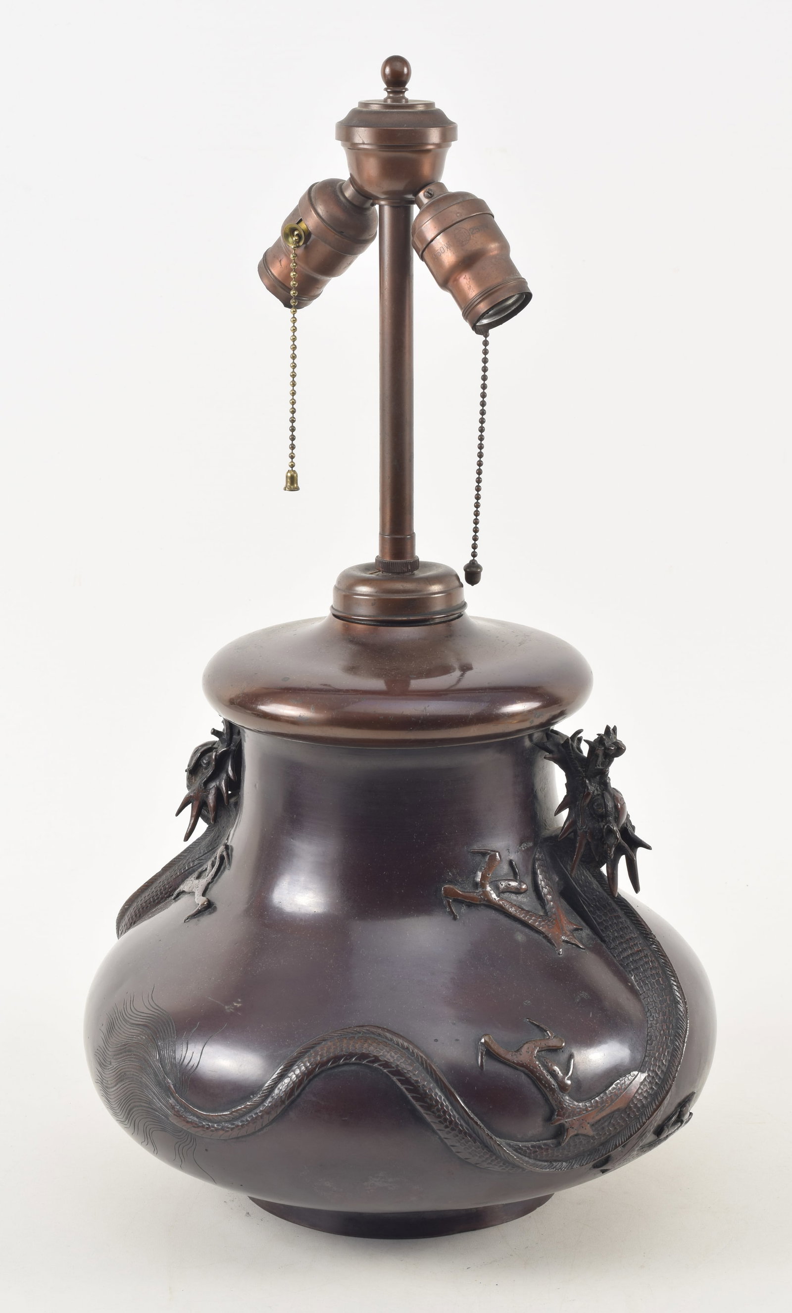Japanese lacquered bronze vase with elaborate relief dragon decoration, late 19th/early 20th: Japanese lacquered bronze vase with elaborate relief dragon decoration, late 19th/early 20th century. Brown red patina. Mounted as a lamp. 22in high overall.
