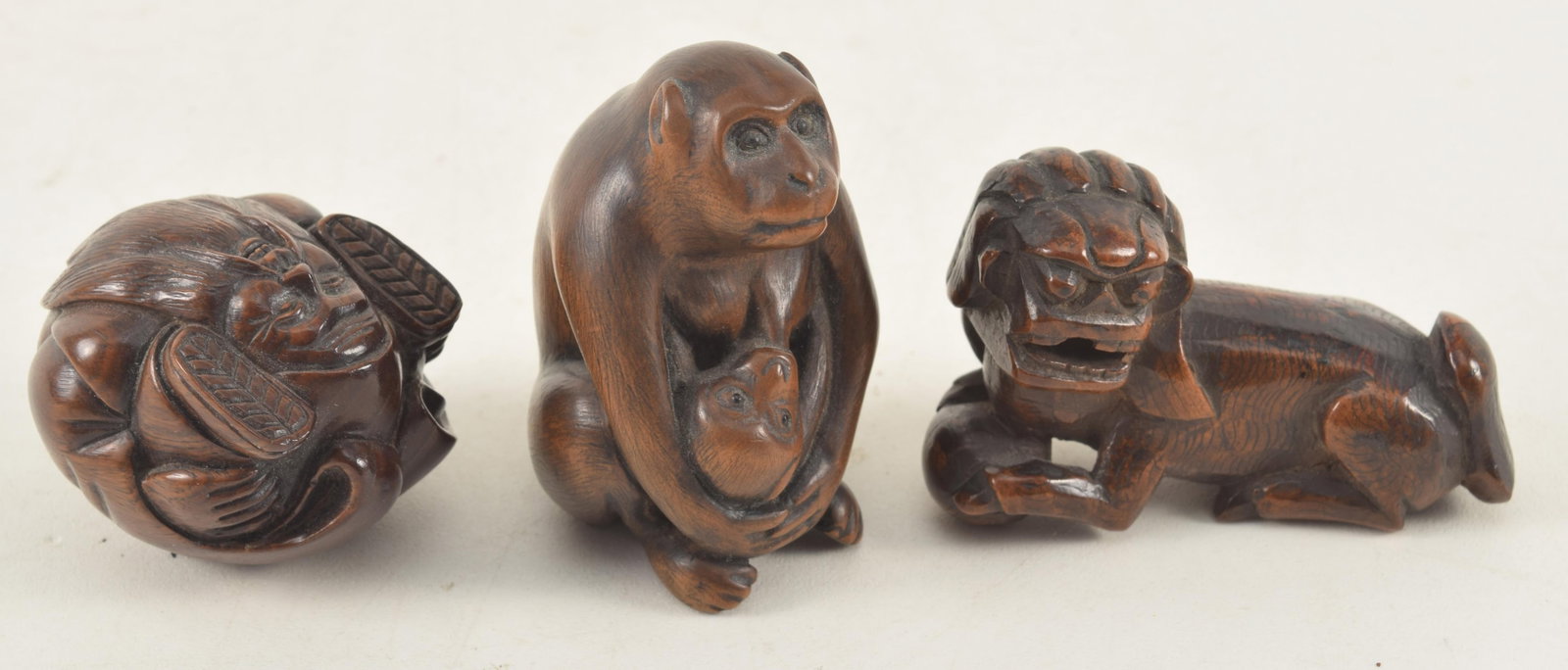 3 Japanese wooden netsukes. 1) 19th/20th century carved wood monkey and baby with inlaid eyes. (1 of 6)