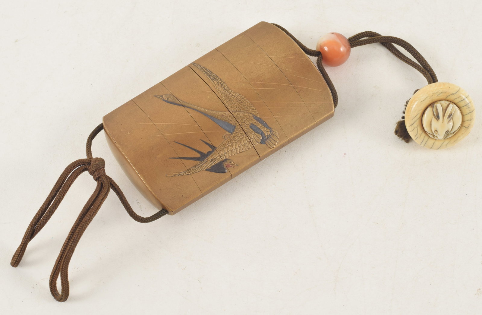 Sagamono. Japan. 19th century. Inro of gold lacquer decorated with geese, carnelian ojime, rabbit (1 of 4)