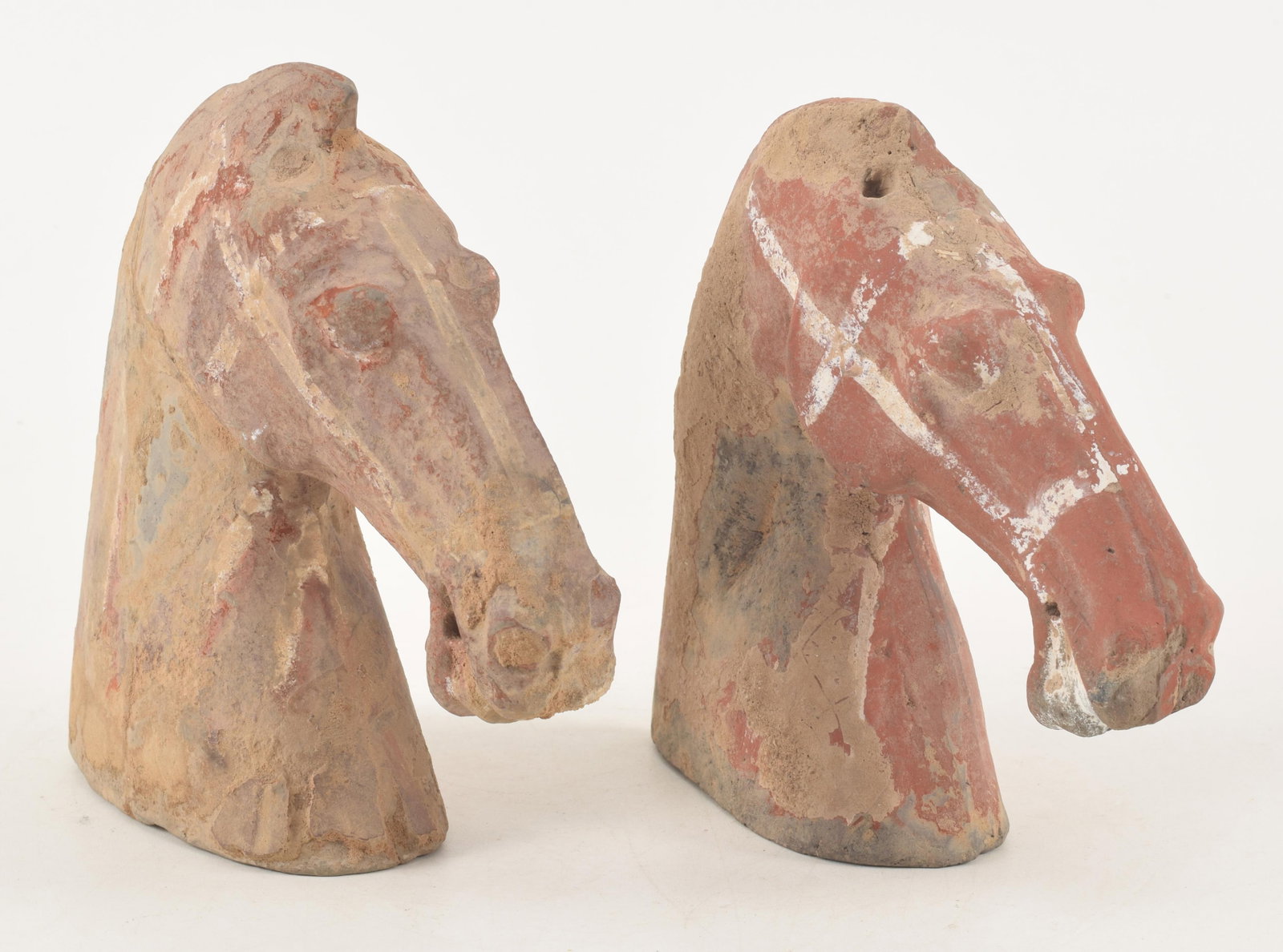 Chinese horse head form tomb figures. Possibly Han period. Traces of pigment. Each 6.25in high. (1 of 6)