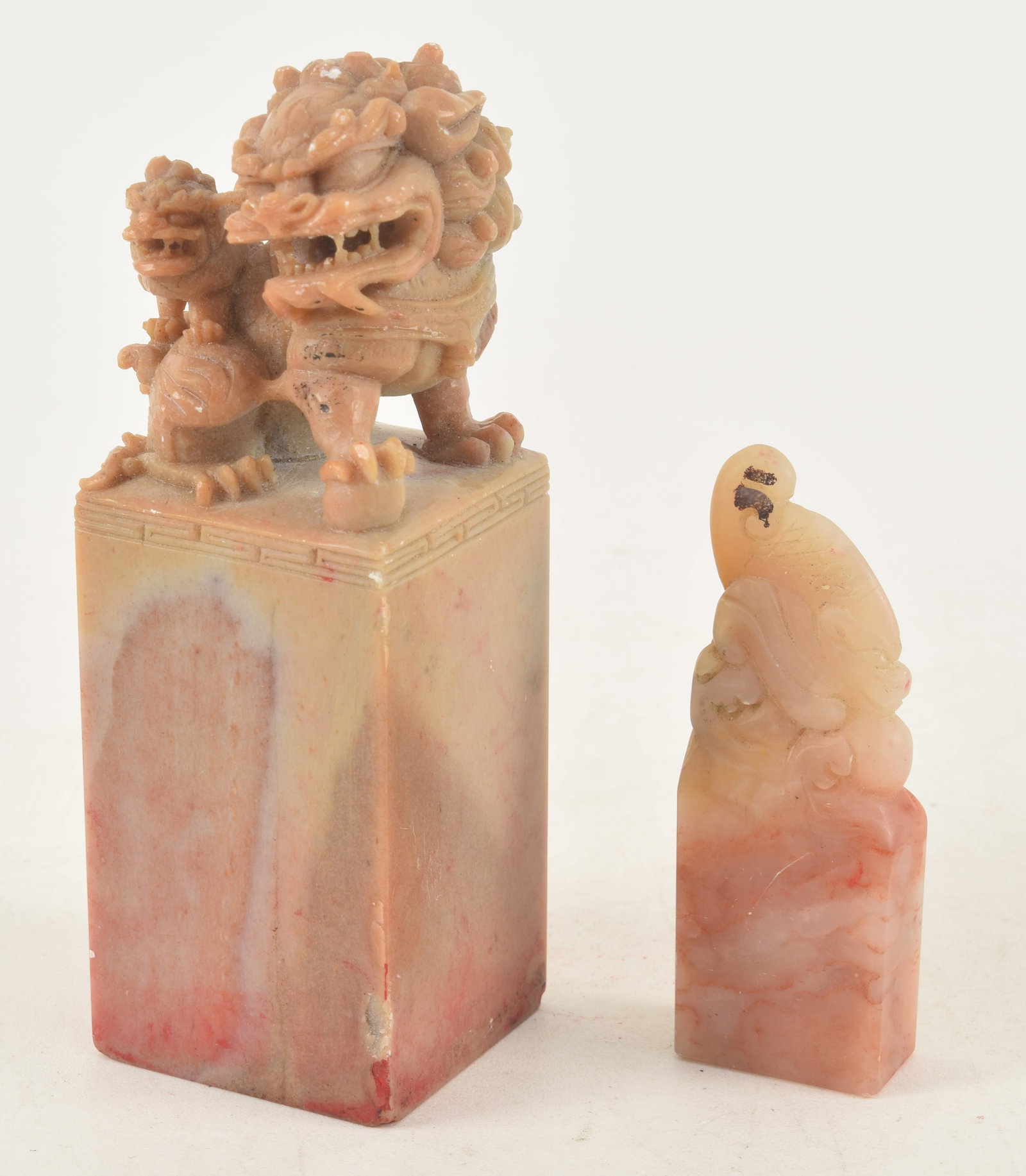 2 early 20th century Chinese soapstone carved seals. Largest with buddhist lions and inscription,: 2 early 20th century Chinese soapstone carved seals. Largest with buddhist lions and inscription, 4.5in high, slight damage on top.