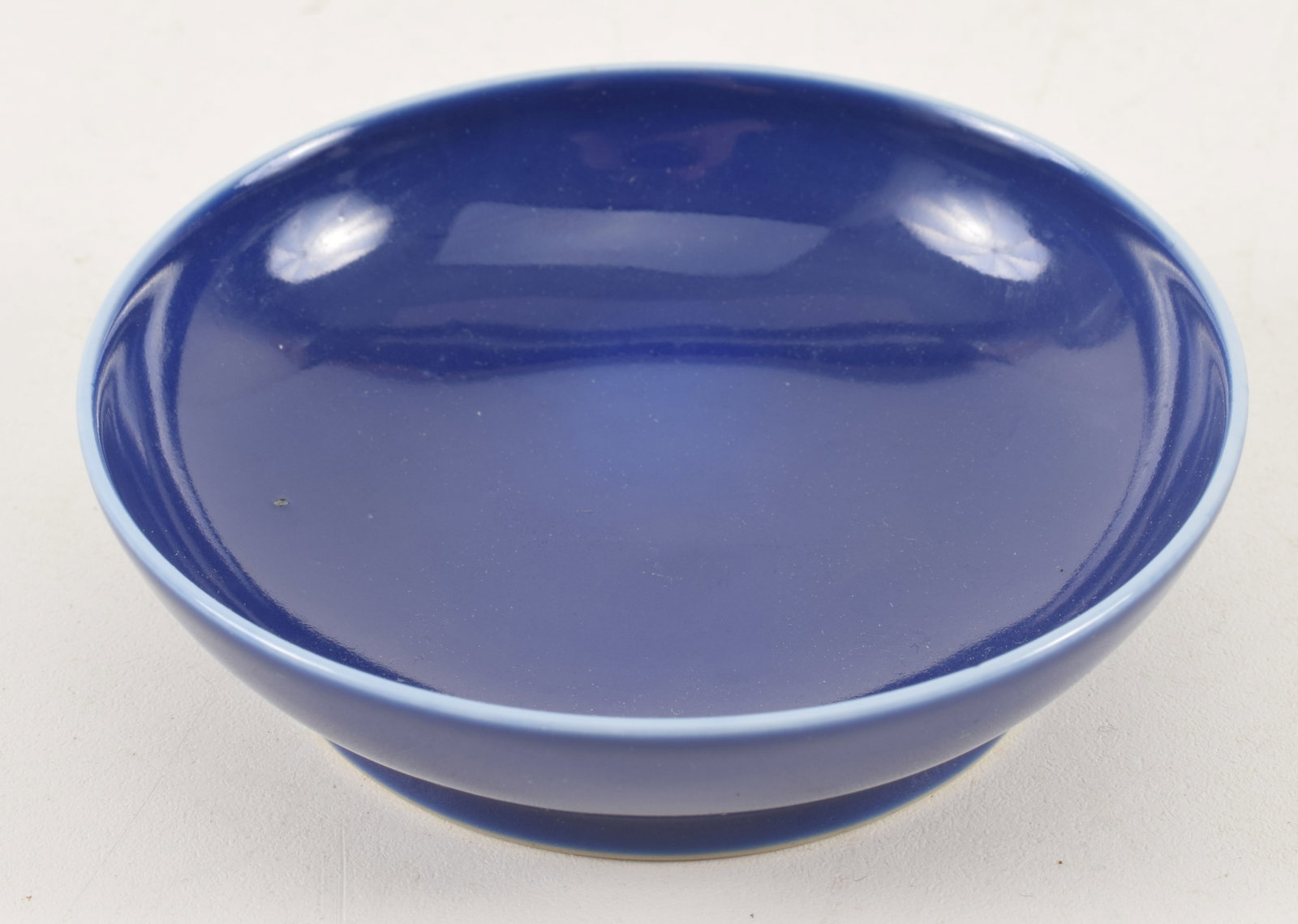 20th century small Chinese monochrome blue porcelain dish. Guangxu mark on base. 3.5in diameter.: 20th century small Chinese monochrome blue porcelain dish. Guangxu mark on base. 3.5in diameter.