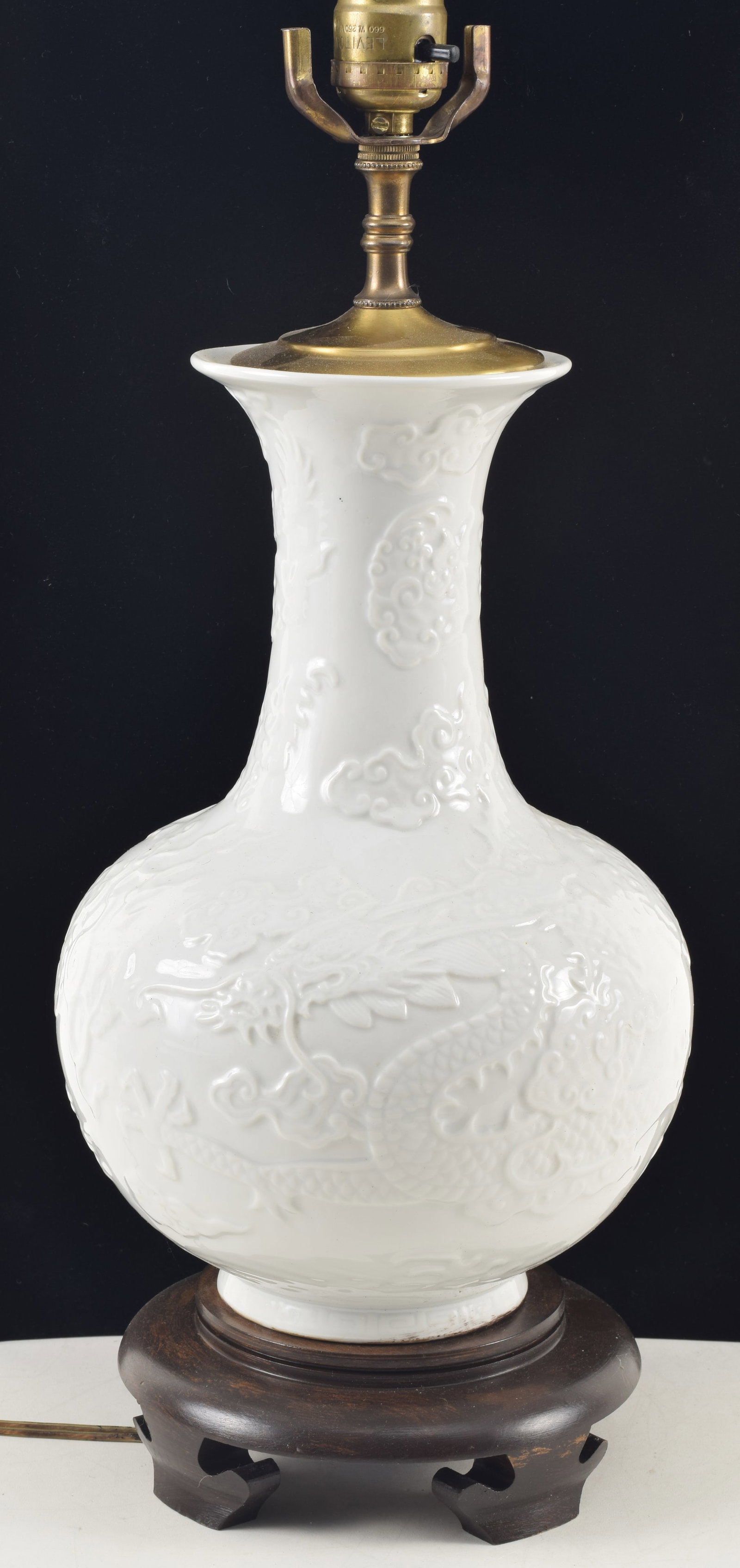 Chinese blanc de chine porcelain vase. 20th century. Raised dragon and clouds decoration. Drilled (1 of 6)