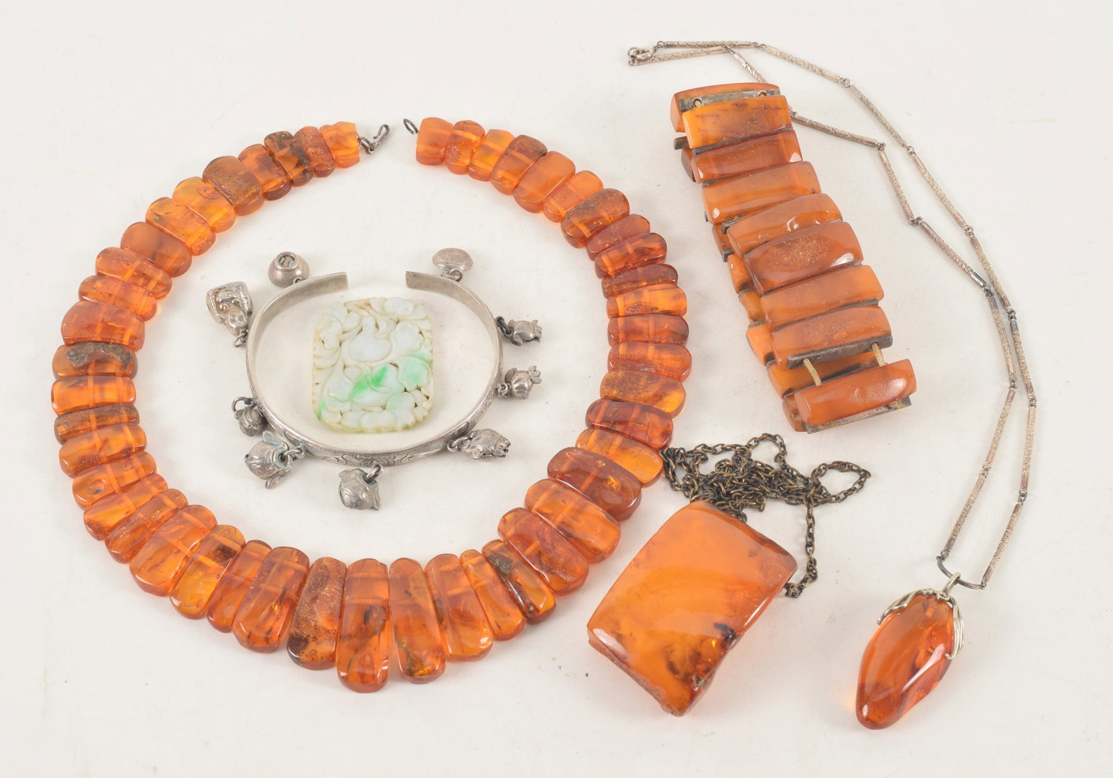 Lot of Chinese amber and silver jewelry. To include: 2 pendant necklaces with large amber specimens, (1 of 5)