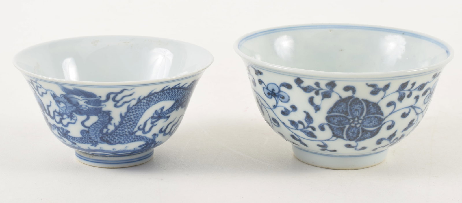 2 Chinese porcelain blue and white bowls. 1 with floral Ming style decoration, 1 with dragon chasing: 2 Chinese porcelain blue and white bowls. 1 with floral Ming style decoration, 1 with dragon chasing pearl. Largest: 4.75in diameter.