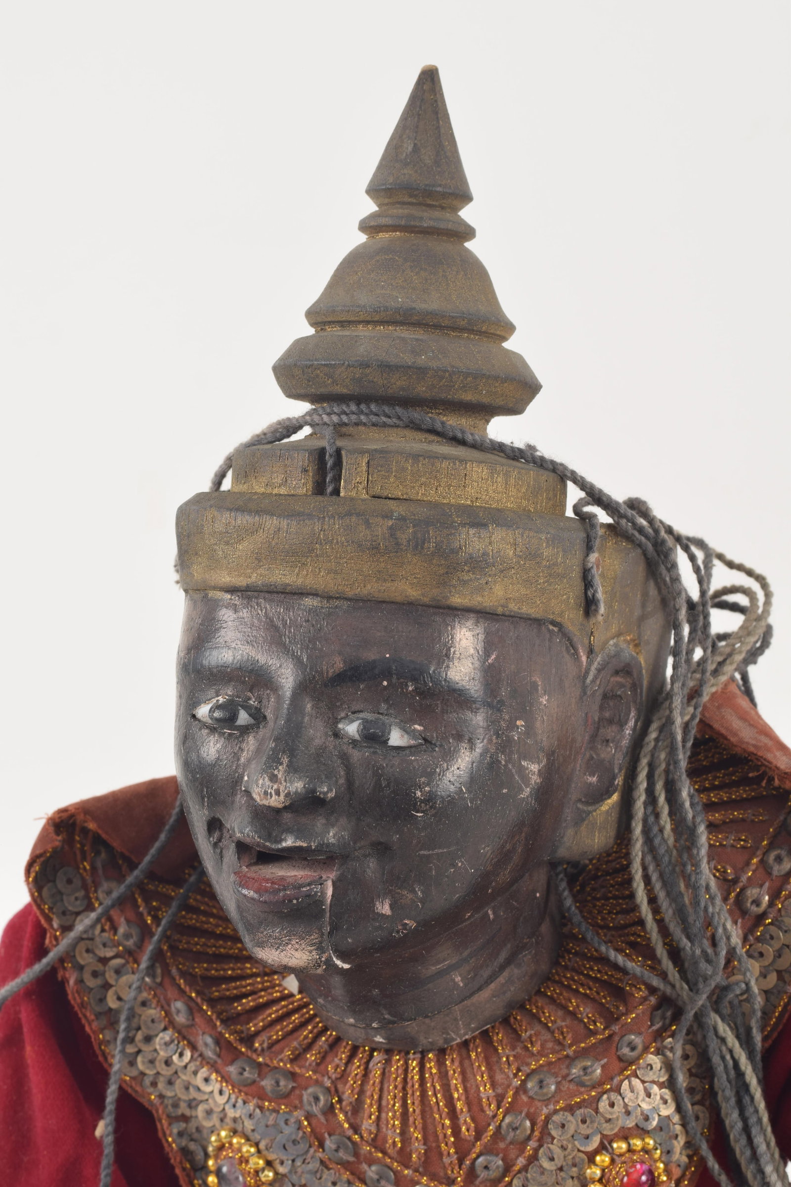 Puppet. Myanmar, ca 1950. Lacquered wooden body. Ornate later robes. About 22in length. - 2