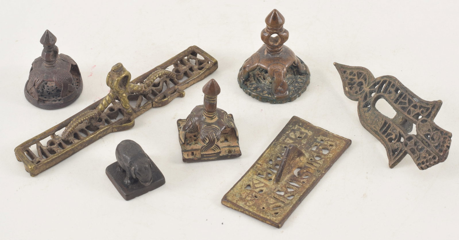 Lot of Asian metal works. To include several bronze seals, weights, and ornaments. Largest: 4.75in. (1 of 4)