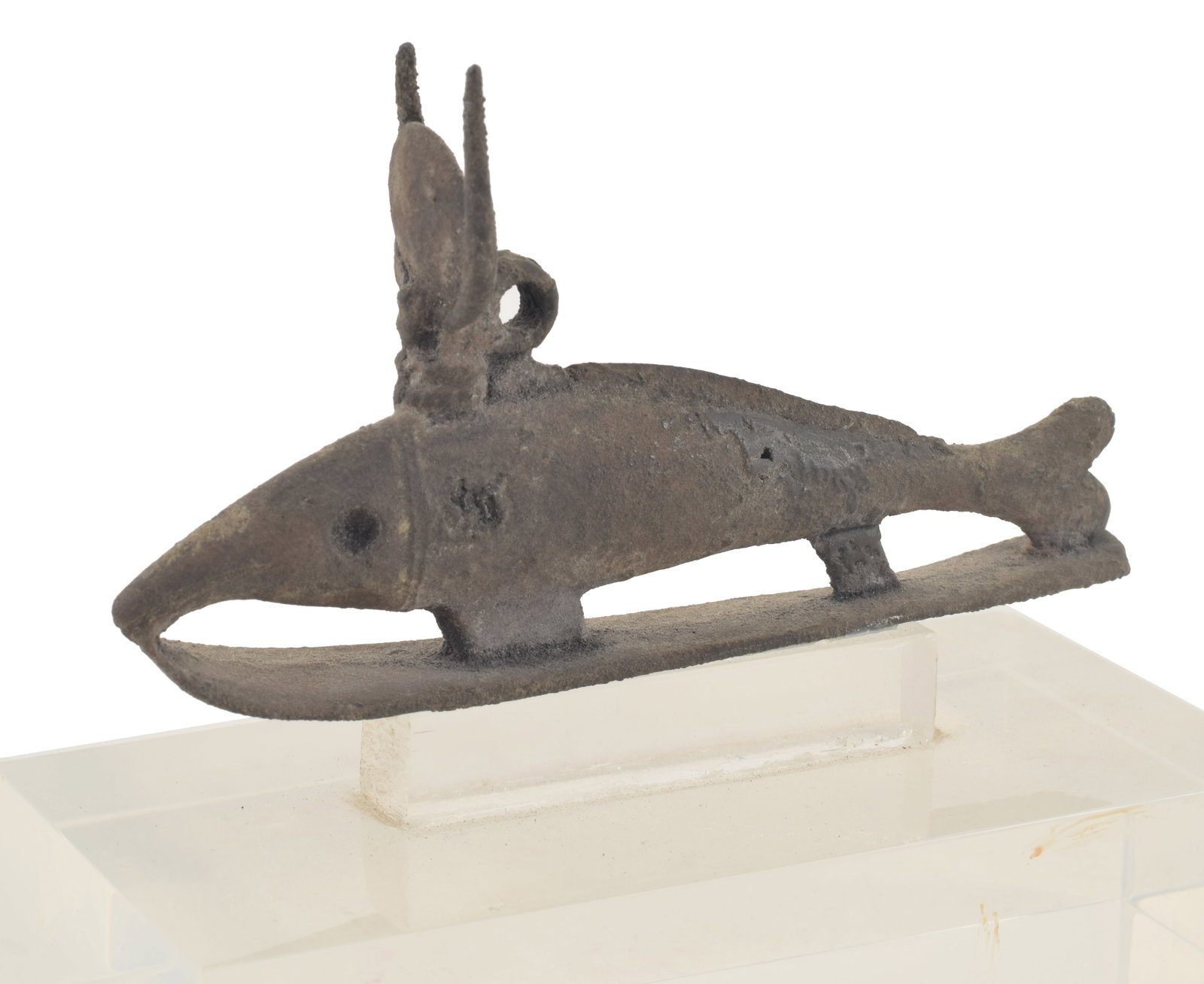 Egyptian, Late Period, bronze figure of a Nile perch. On a sledge wearing a celestial disk and: Egyptian, Late Period, bronze figure of a Nile perch. On a sledge wearing a celestial disk and horns. Length 4 7/8 in. From the collection of Dr. Bruce L. Ralston, Tuxedo Park NY. Dr. Ralston assemble
