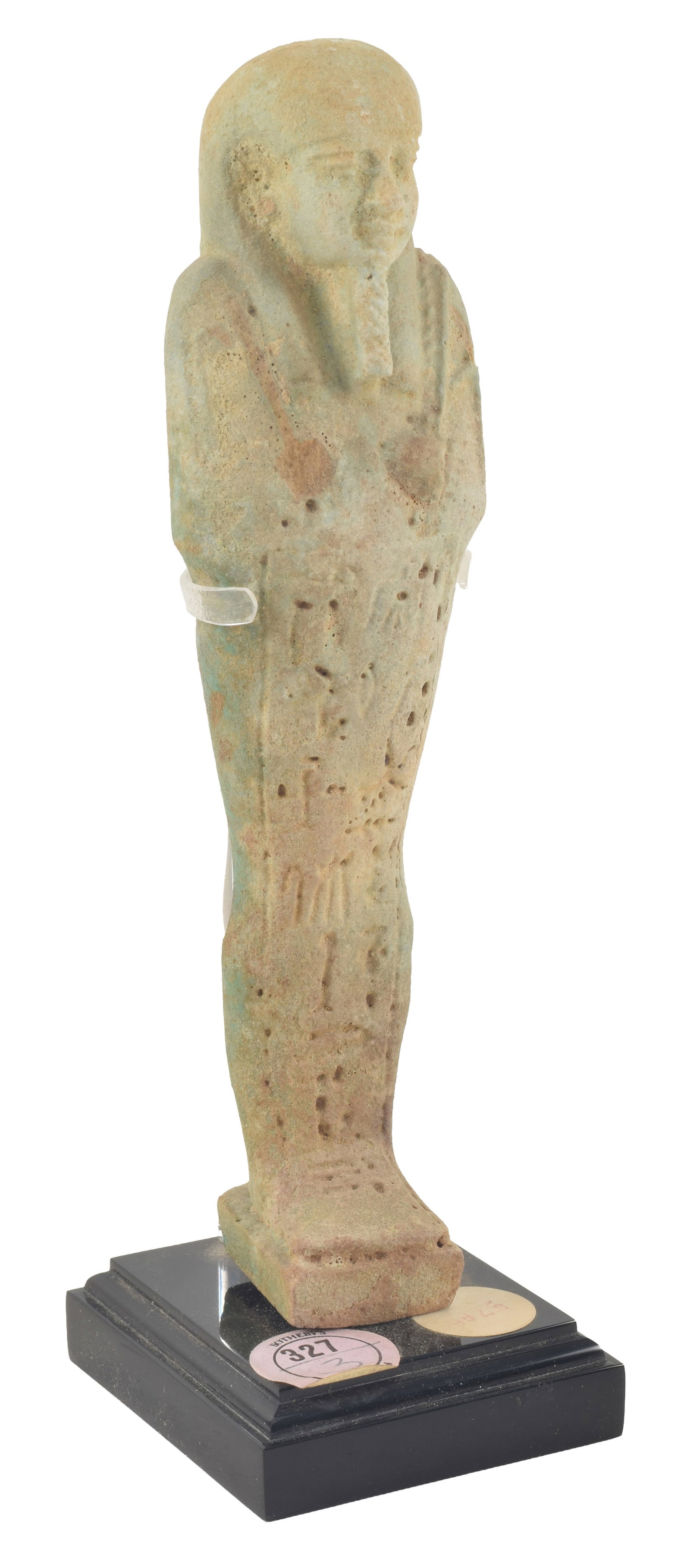 Egyptian, 26th/30th dynasties, pale green faience ushabti figure. Modeled with pick and hoe, and (1 of 8)
