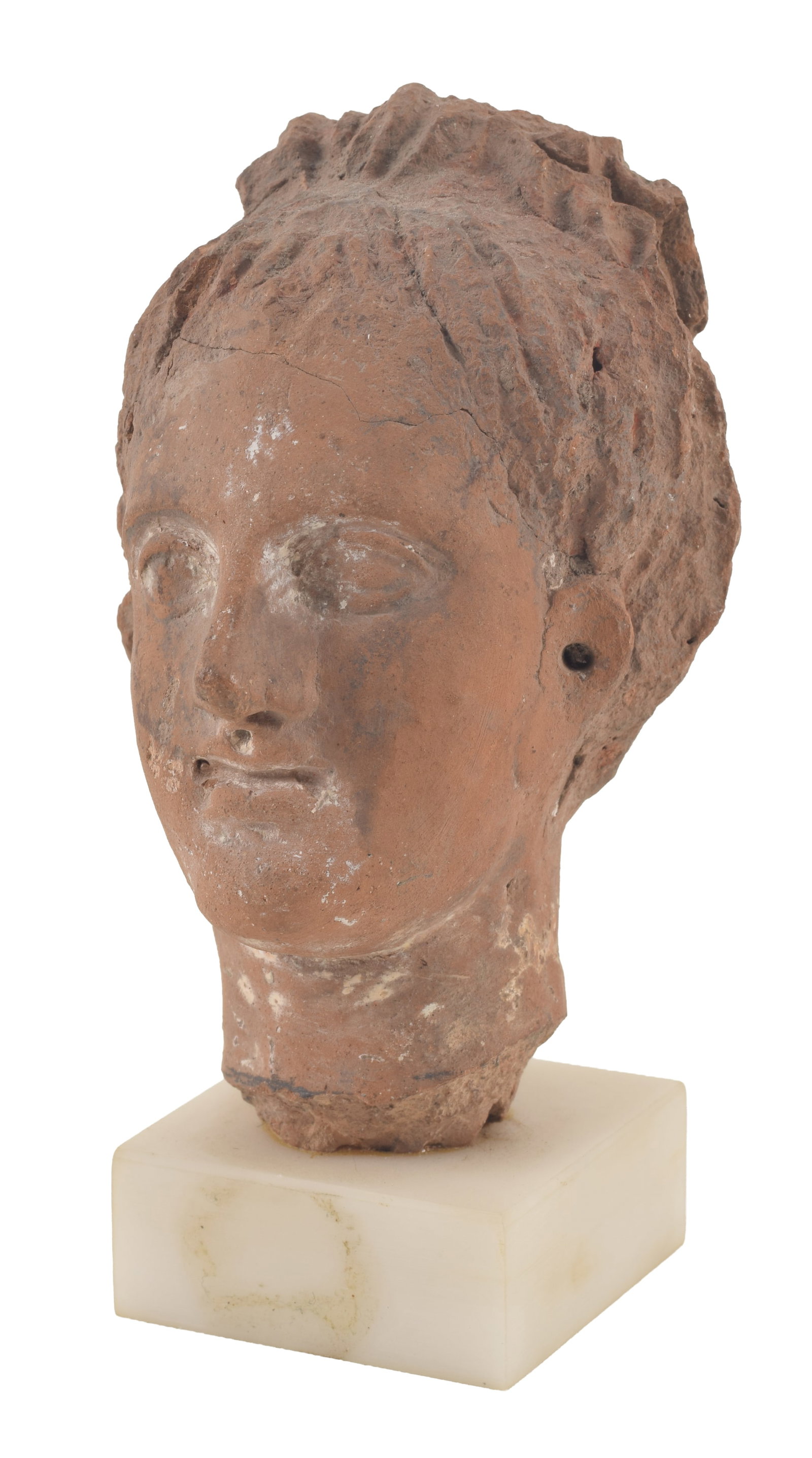 Helenistic earthenware head of a woman. Fragment with hair and pierced ears. On a marble stand.: Helenistic earthenware head of a woman. Fragment with hair and pierced ears. On a marble stand. Height 4.25in. From the collection of Dr. Bruce L. Ralston, Tuxedo Park NY. Dr. Ralston assembled a larg