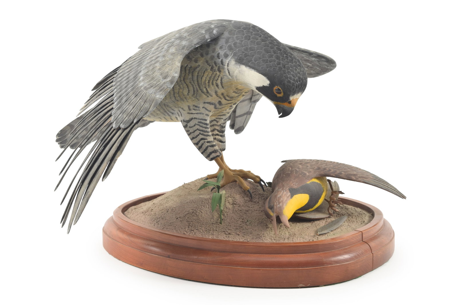 Delmer Ford. Fine quality wood carving of a Peregrine Falcon and its prey. Signed on the base.: Delmer Ford. Fine quality wood carving of a Peregrine Falcon and its prey. Signed on the base. Several wing feathers with minor repairs. Approximately 20in wide.
