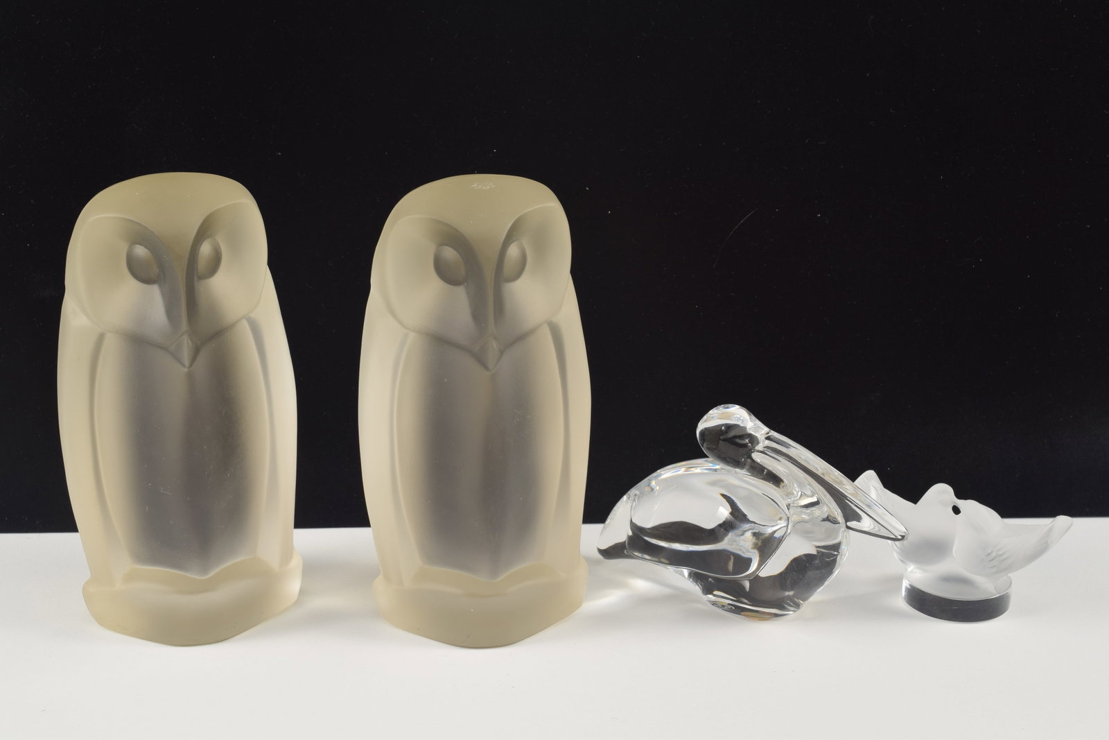 4 glass figurines. 1) Pair of Art Deco style frosted glass own figures. 6in high. 2) Lalique frosted (1 of 6)