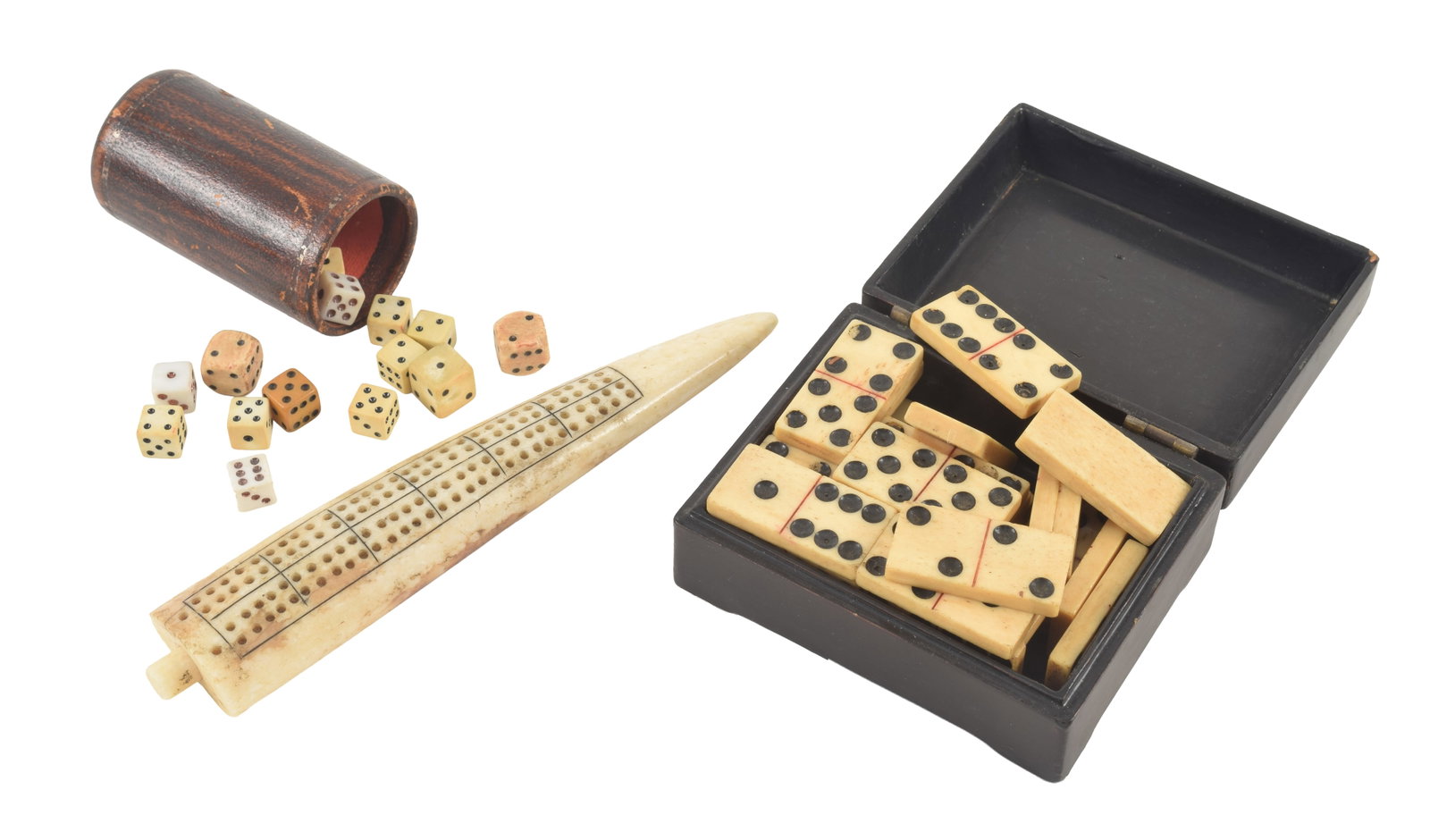 Collection of bone gaming pieces including a group of early dice, dominos and a cribbage board, late (1 of 5)